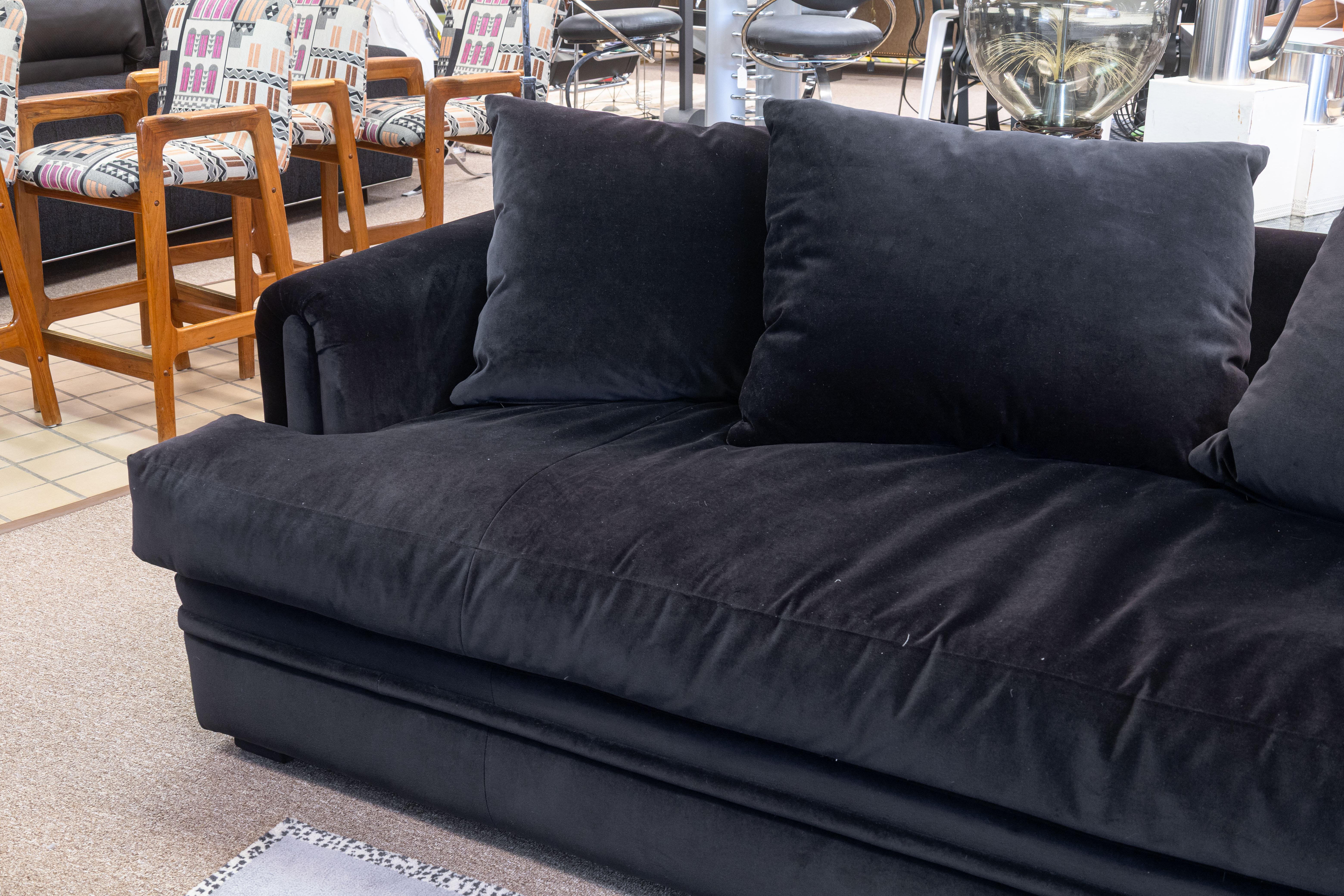 An A. Rudin custom made velvet sofa. This gorgeous contemporary modern sofa features a stunning custom, handmade design from A. Rudin, an Los Angeles-based custom furniture producer. This sofa features a beautiful deep plum colored velvet