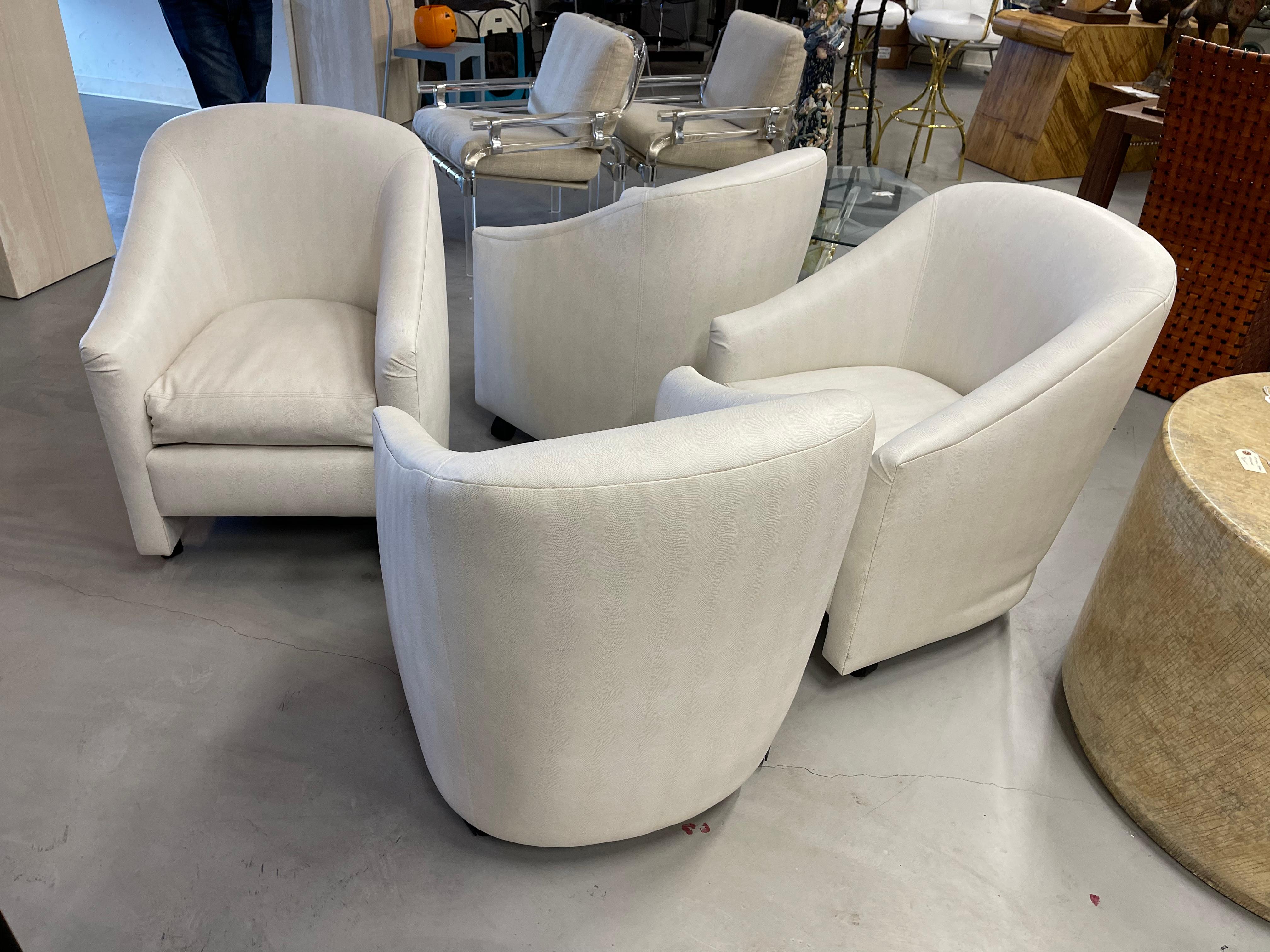 A nice set of 4 vinyl (we believe) chairs on castors. Perfect for a game table or small kitchen table. In a faux lizard pattern. The chairs are labeled A. Rudin. In good overall condition but the leather has some marks that may be cleanable.