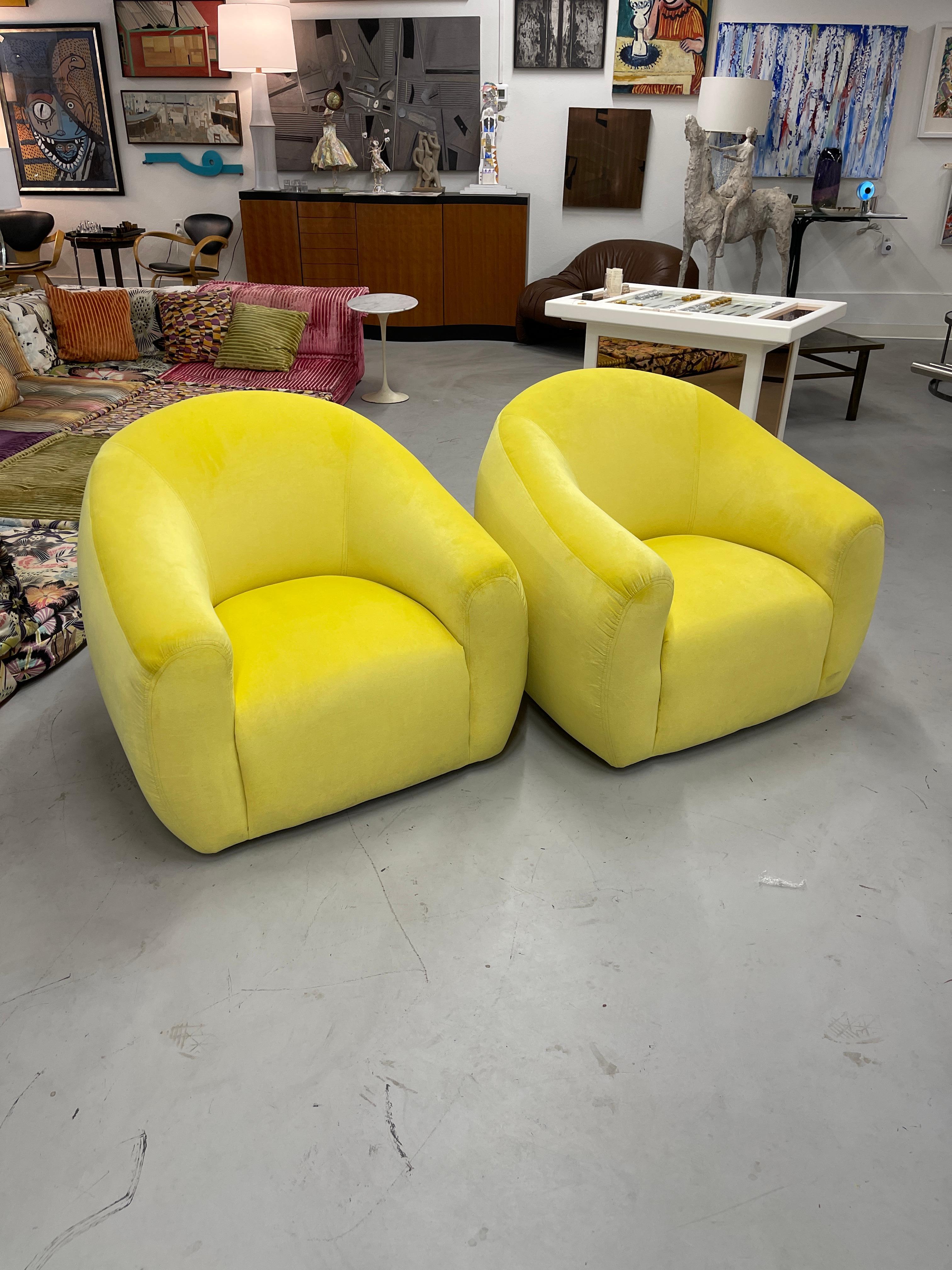 A stunning pair of vintage A. Rudin swivel chairs totally reimagined and reupholstered in a vibrant Kravet Rioma Limon color. The chairs have been reshaped by our upholsterer into a generous and extremely comfortable pair of chairs. Great detail