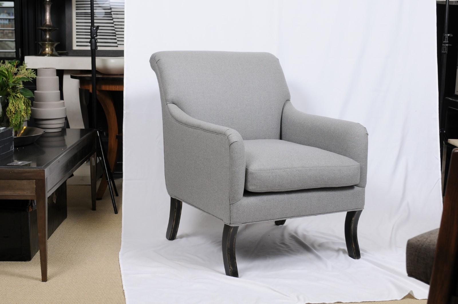Upholstered armchairs by A. Rudin that feature a gracefully rolled crest rail that echoes the line of the English rolled arms. Cabriole front legs add further movement to the chairs. They are upholstered in a light gray wool by Holland & Sherry. 2