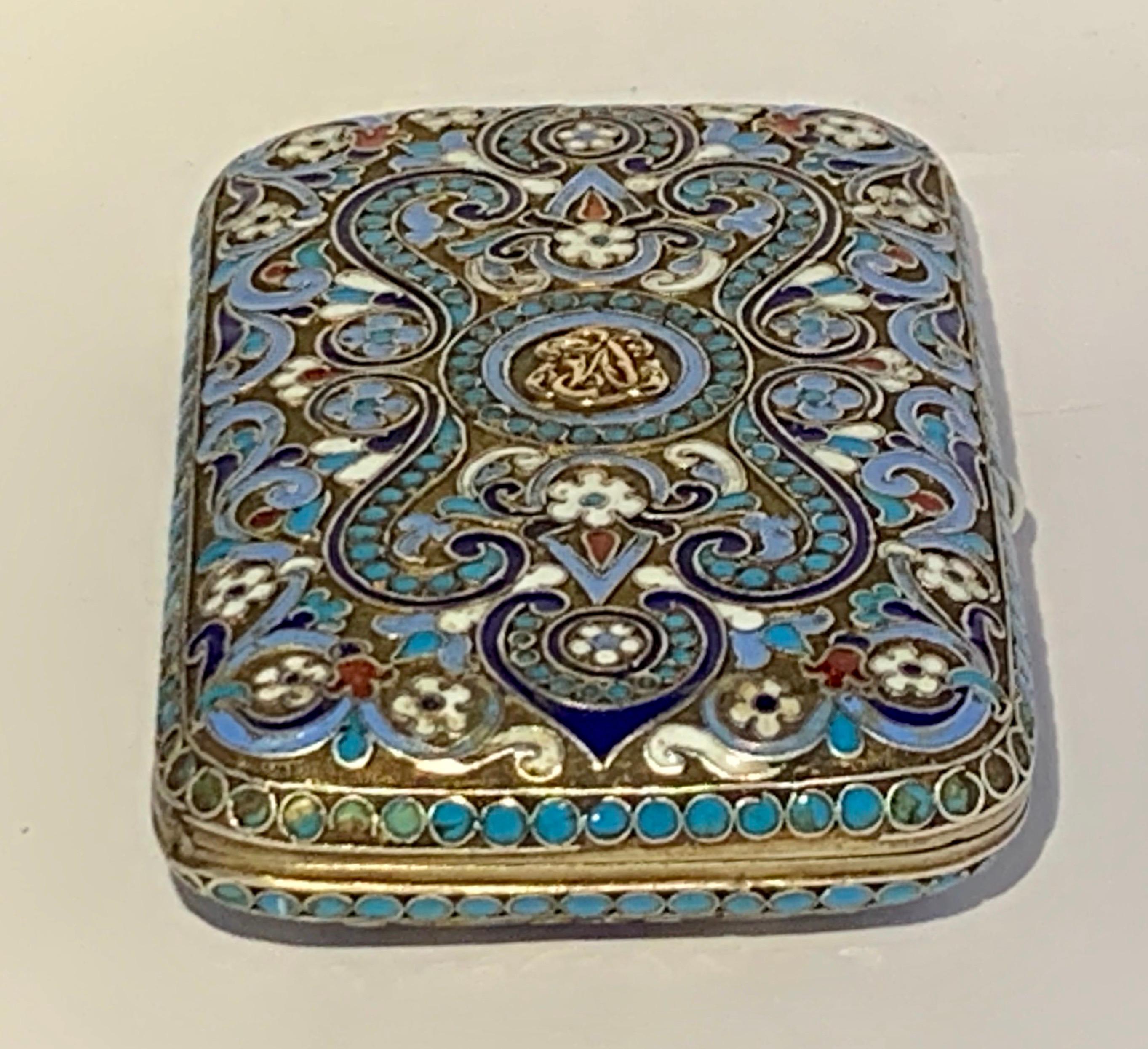 The date mark that is stamped on this box is 1894
Assayer's mark AA (Anatoly A Artsybashev).
Cover and sides with foliate scrolls in red, white, a gold initial on top,mauve, apple-green and three shades of blue within turquoise blue bead borders,