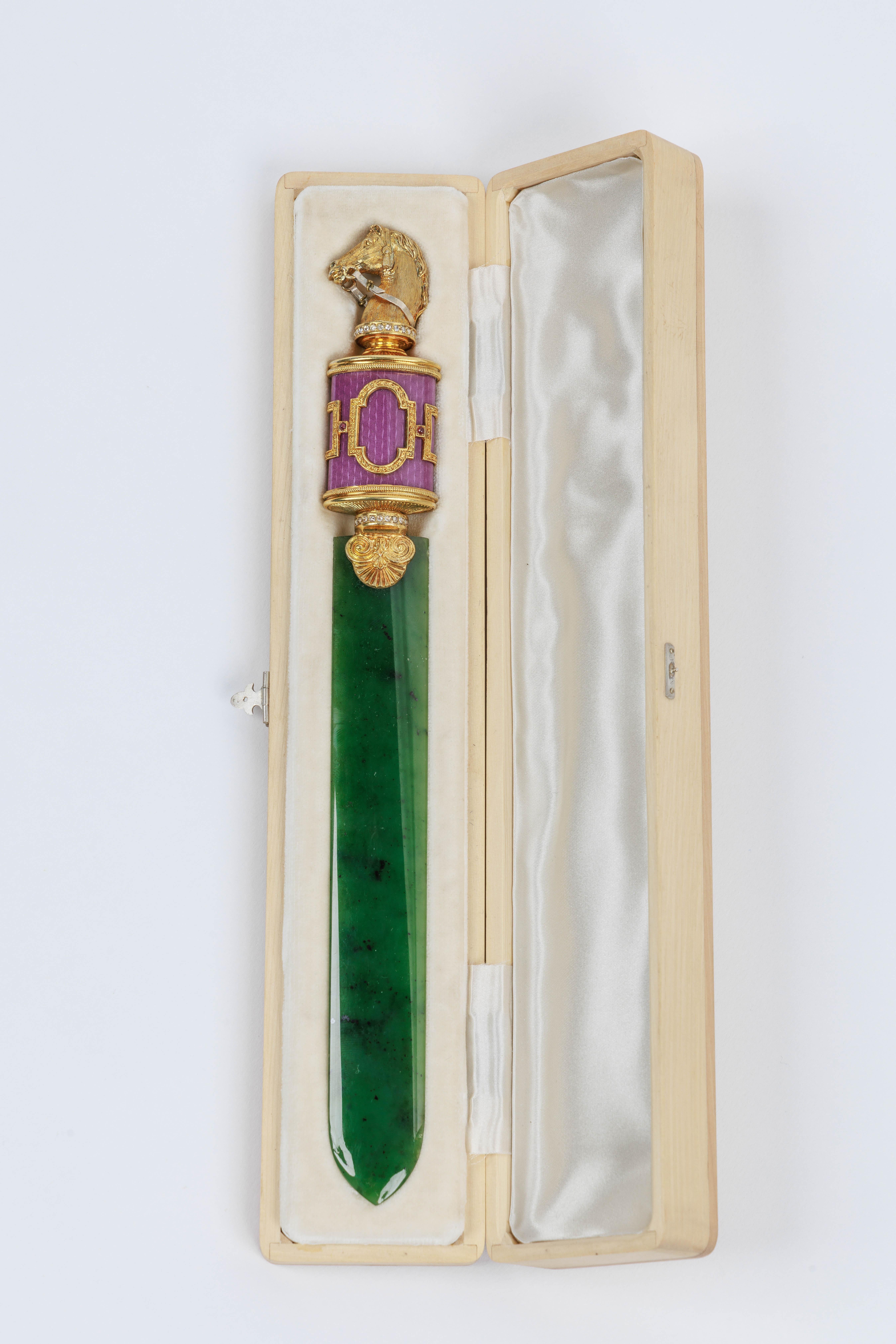 A Russian Silver-Gilt, Diamonds, Nephrite, and Purple Guilloche Enamel Letter Opener, with a horse head, in original fitted box.

Exquisite jewel like quality, in the Faberge style.

Measures 10