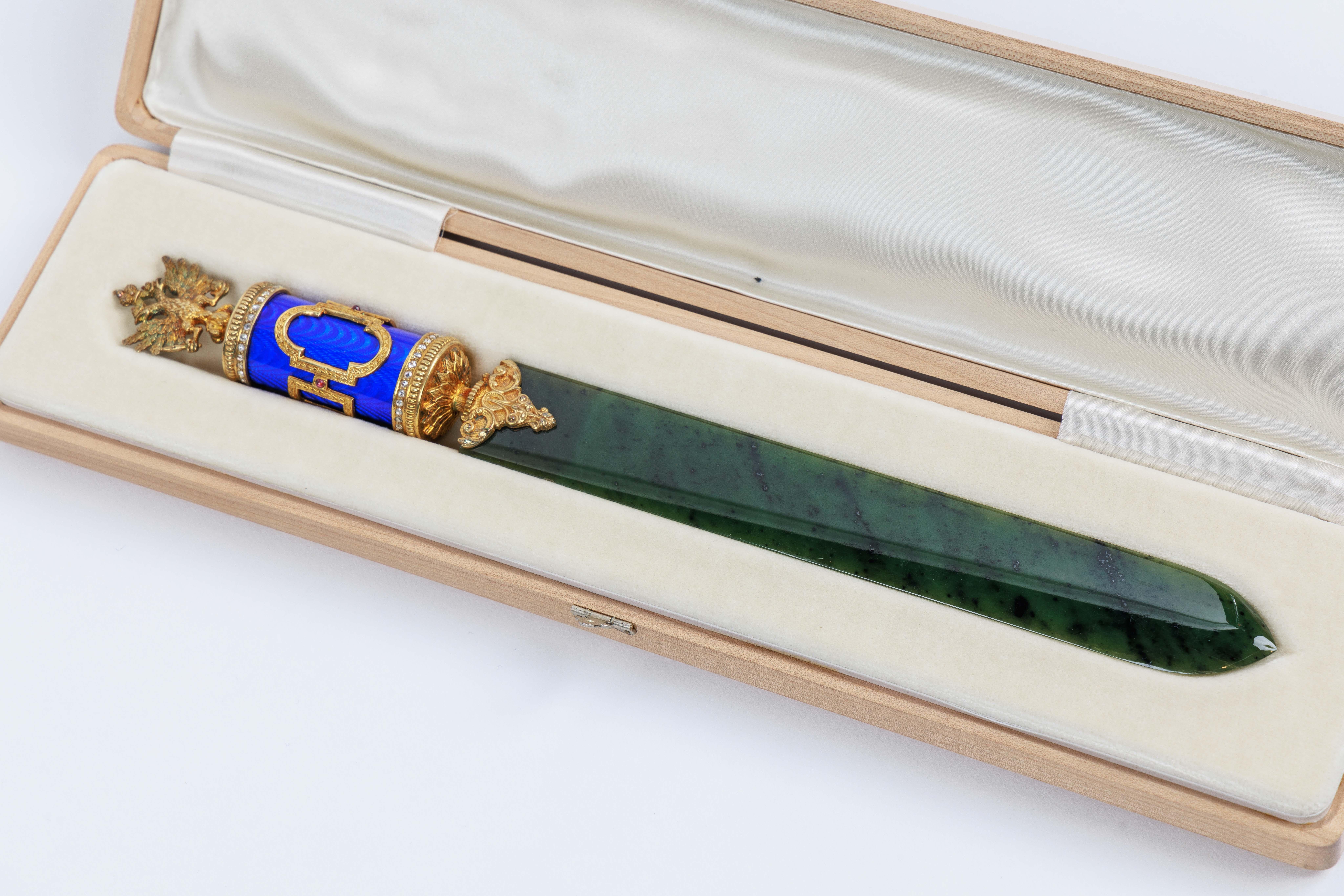 A Russian Silver-Gilt, Diamonds, Nephrite, and Blue Guilloche Enamel Letter Opener, with a Russian Double Eagle, in original fitted box.

Exquisite jewel like quality, in the Faberge style.

Measures 10