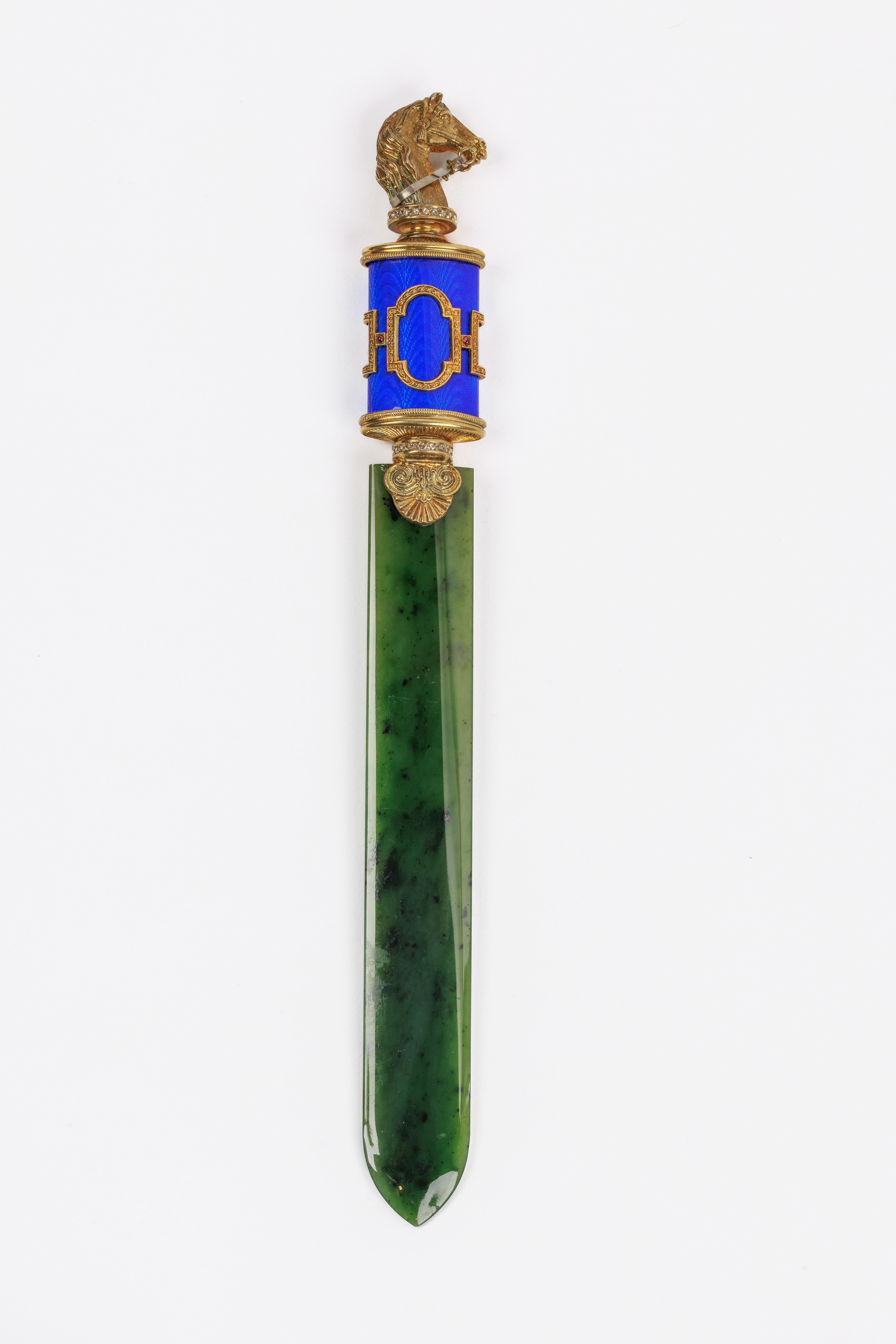 A Russian Silver-Gilt, Diamonds, Nephrite, and Blue Guilloche Enamel Letter Opener, with a horse head, in original fitted box.

Exquisite jewel like quality, in the Faberge style.

Measures 10
