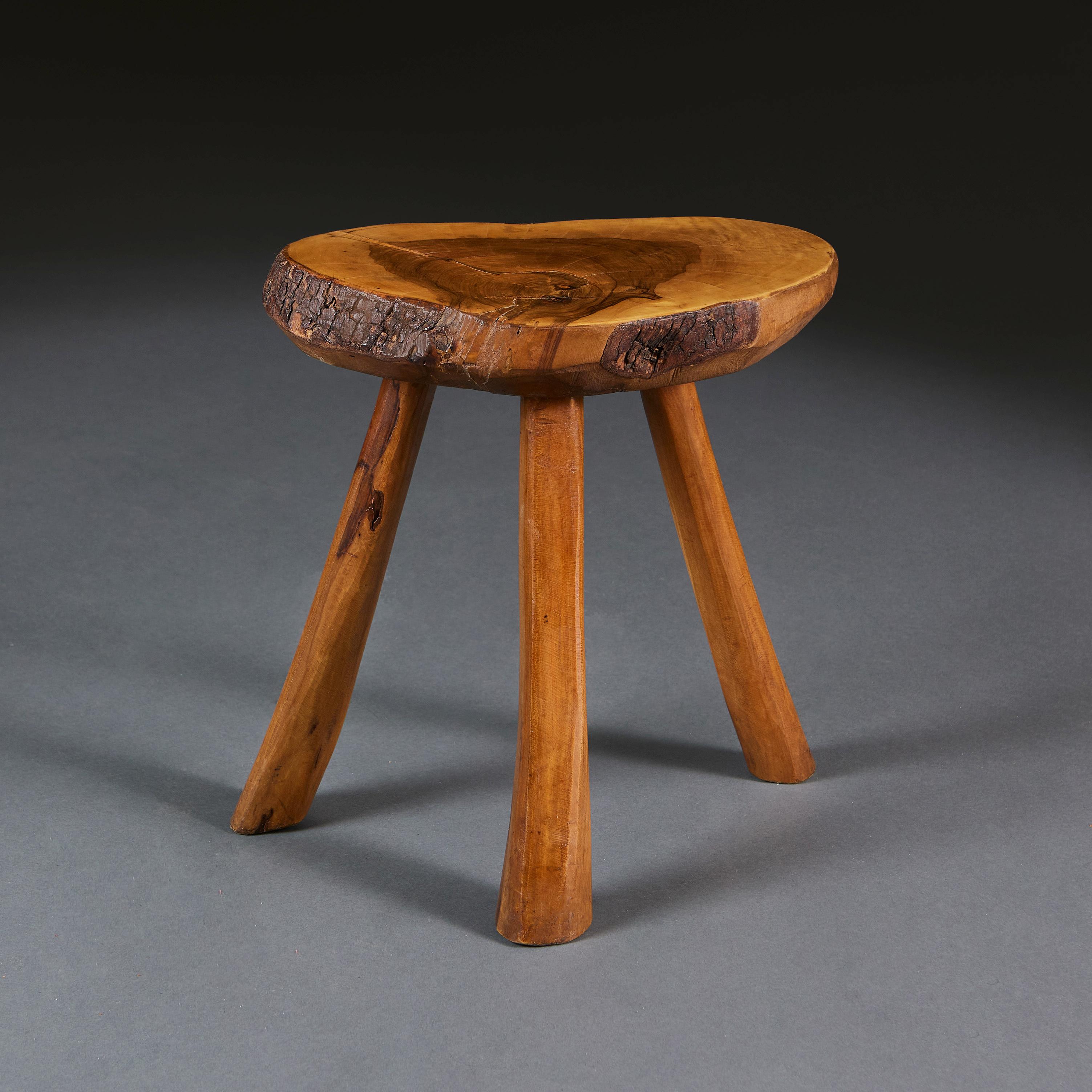 England, circa 1910

An early 20th century elm wood cricket table, the top naturally shaped and with its bark edge, supported on a tripod base with inverted tapering legs.

Height 35.00cm
Width 36.00cm
Depth 26.00cm.