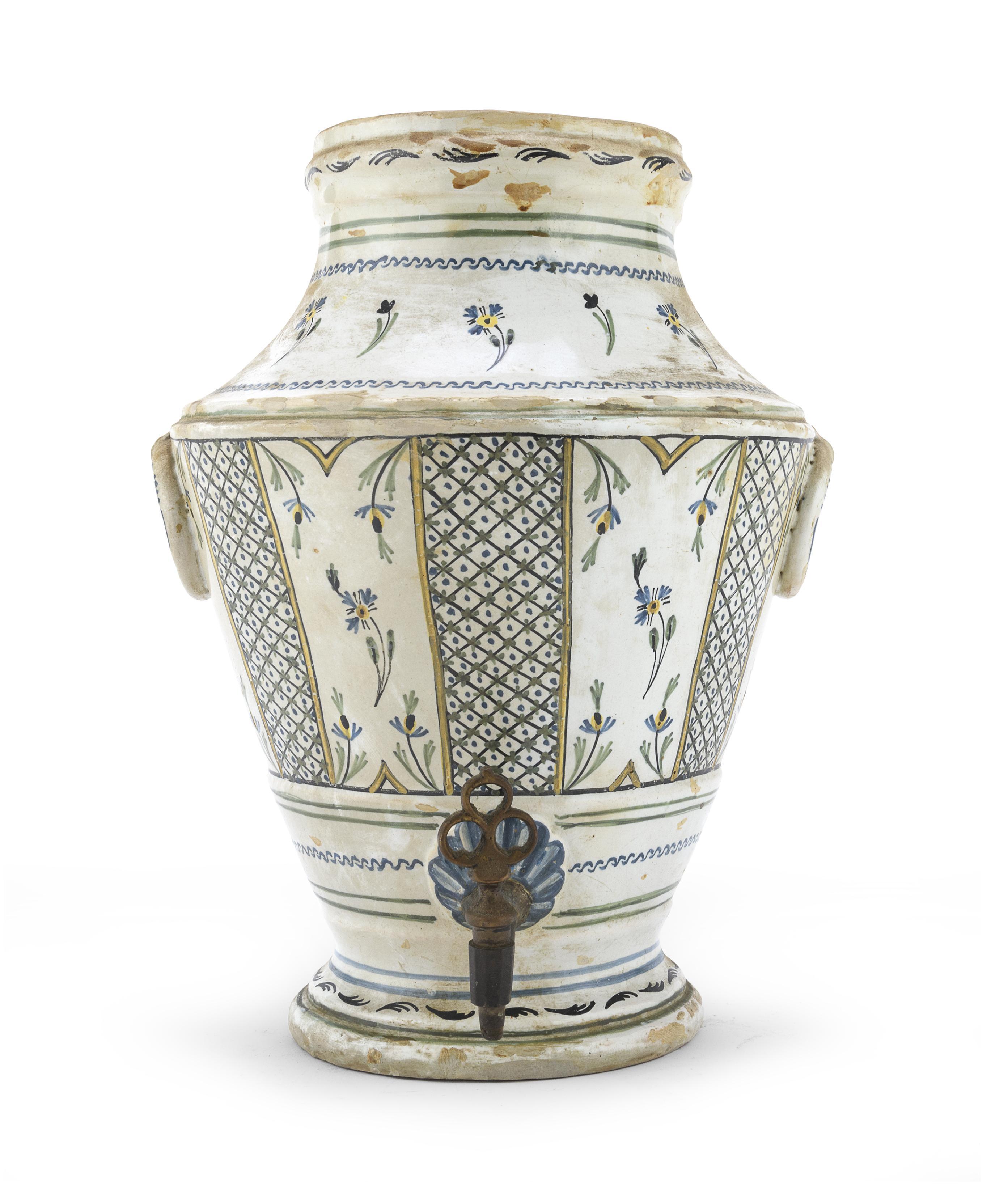 Anonymous
Mid-18th century; probably Moustiers or Nevers, France
Faience and brass

Approximate size: 12.25 (h) x 9 (w) x 6.25 (d) inches

The present dispenser was either used as a water or wine cooler or possibly for washing hands. The original
