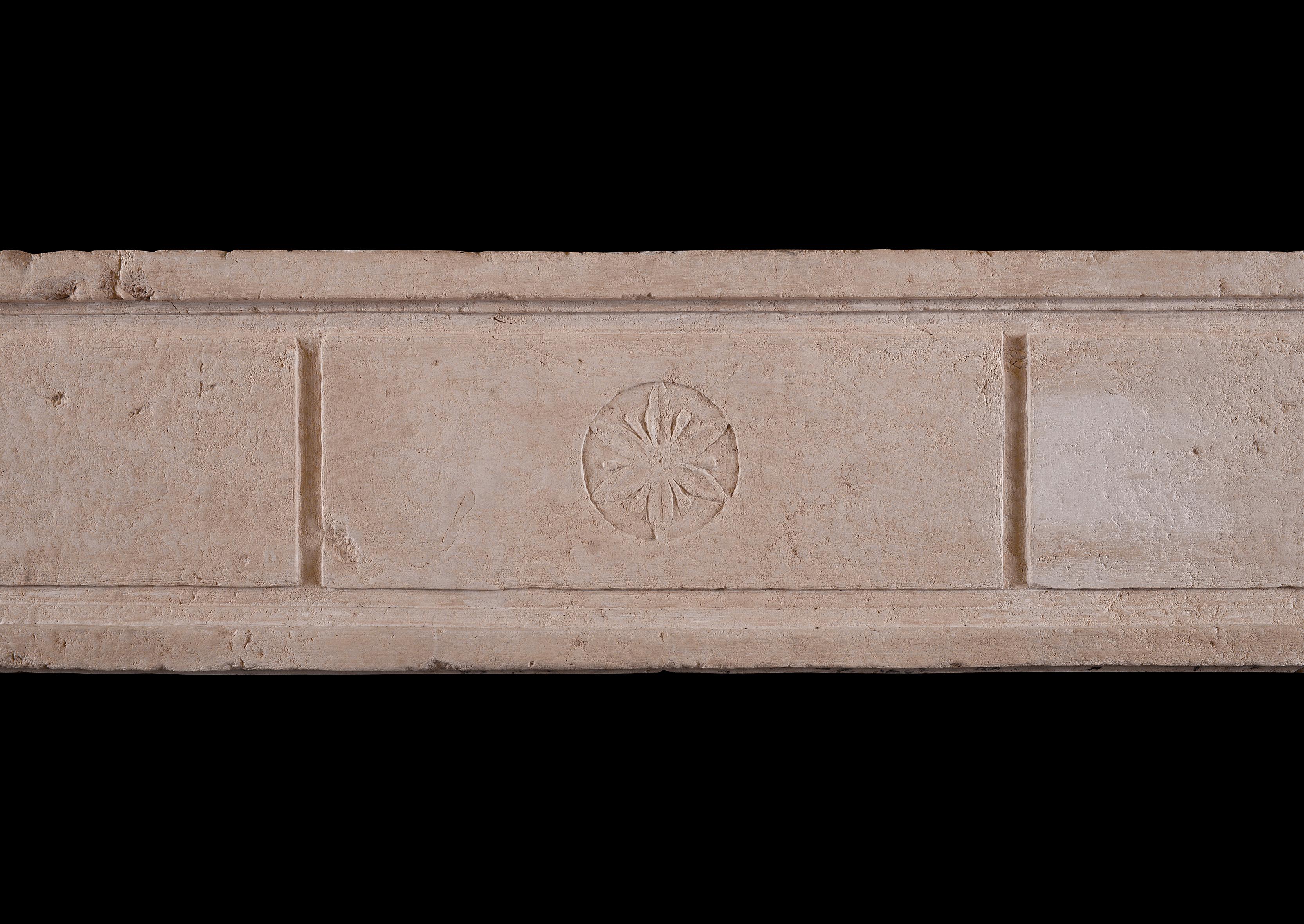 A rustic and substantial Caen stone fireplace. The solid, panelled jambs surmounted by frieze with star motifs throughout. Rustic feel throughout, not overly restored. French, 18th century.

Shelf Width:	1575 mm      	62