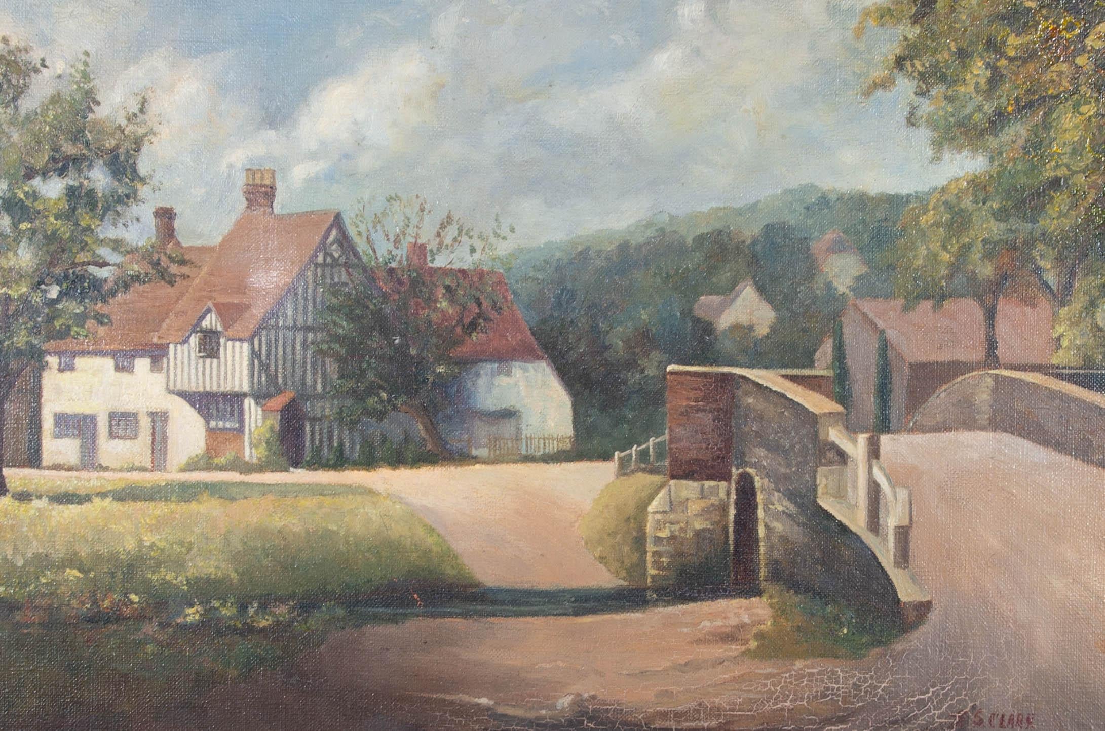 This delightful village scene depicts a Tudor style house on a green with a small bridge to the right. The artist paints in a realist style with bold lines and a matte palette. Signed to the lower right. Presented in a decorative gilt frame. On
