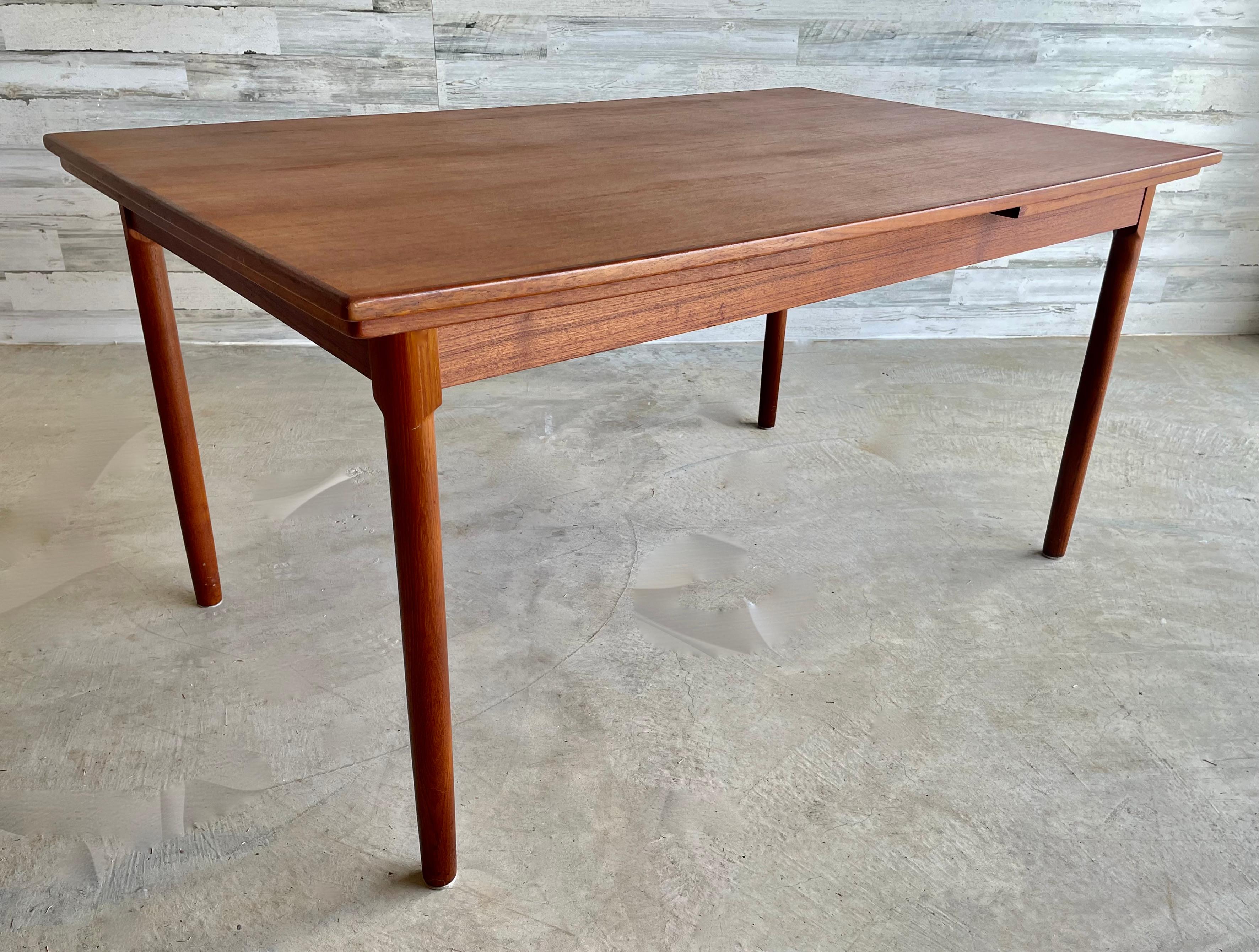 A/S Randers Møbelfabrik Danish teak draw leaf dining table. Original Label Under the Table top.
Total length with both leaves extended 101 inches long. Each leaf is 21.25 L.