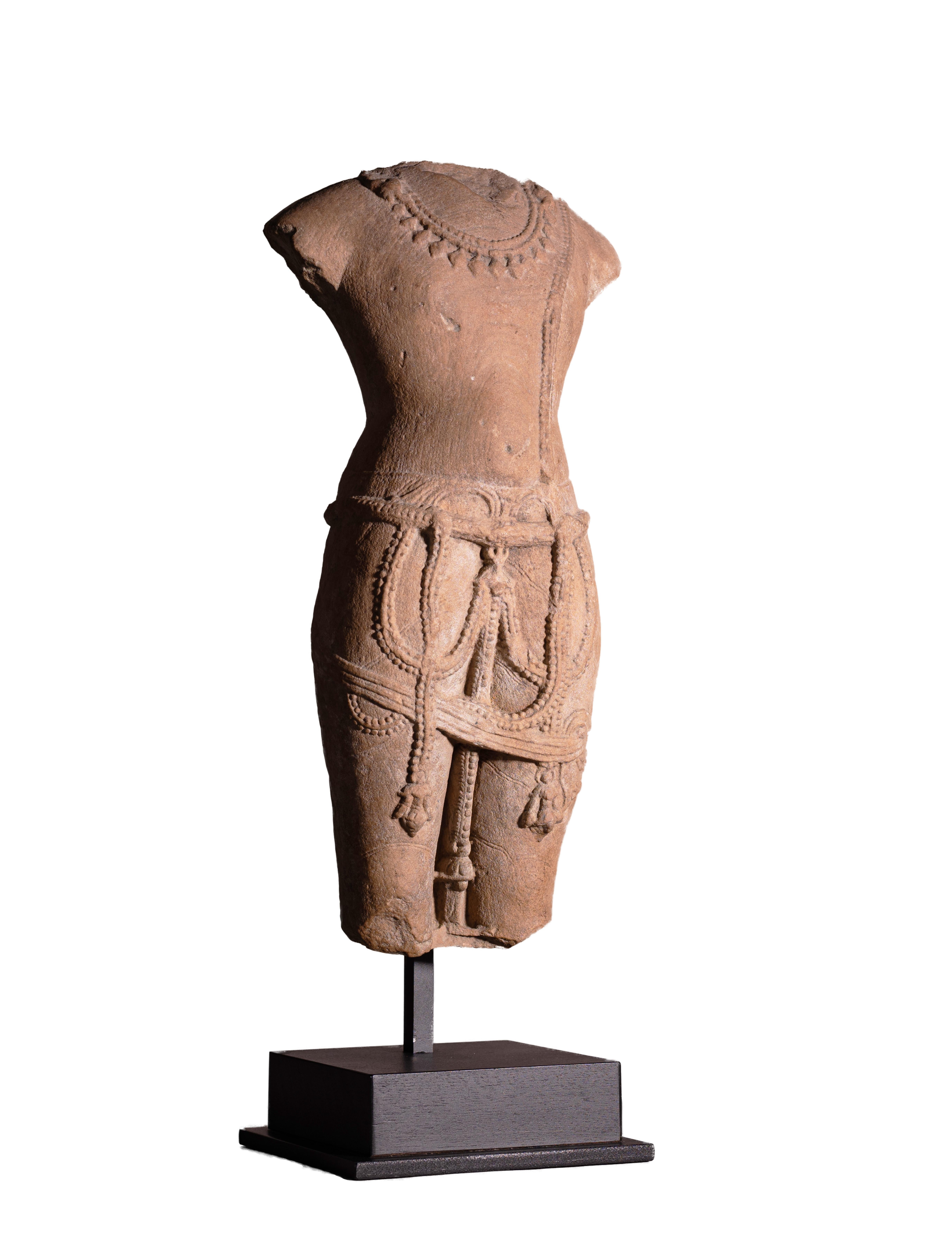 A Pink-beige Sandstone Torso of a Male Deity, likely Vishnu from Uttar Pradesh state in India, circa 10-11th century.

The figure is deeply carved and quite sensuous with pronounced curves which fits well with an idealized depiction of a Male deity