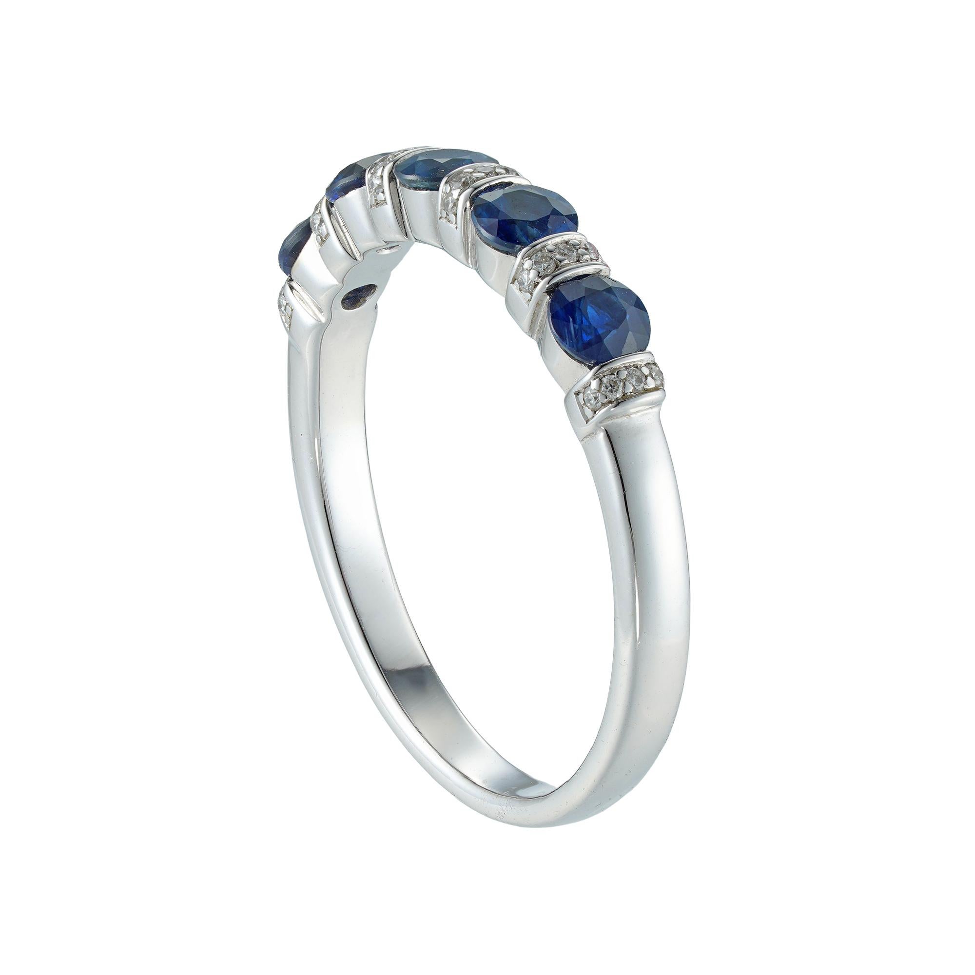 A sapphire and diamond half eternity ring, consisting of five round brilliant-cut sapphires weighing 0.77 carats in total, tension-set between six round- brilliant-cut diamond-set sections, the diamonds weighing 0.06 carats in total, all mounted in