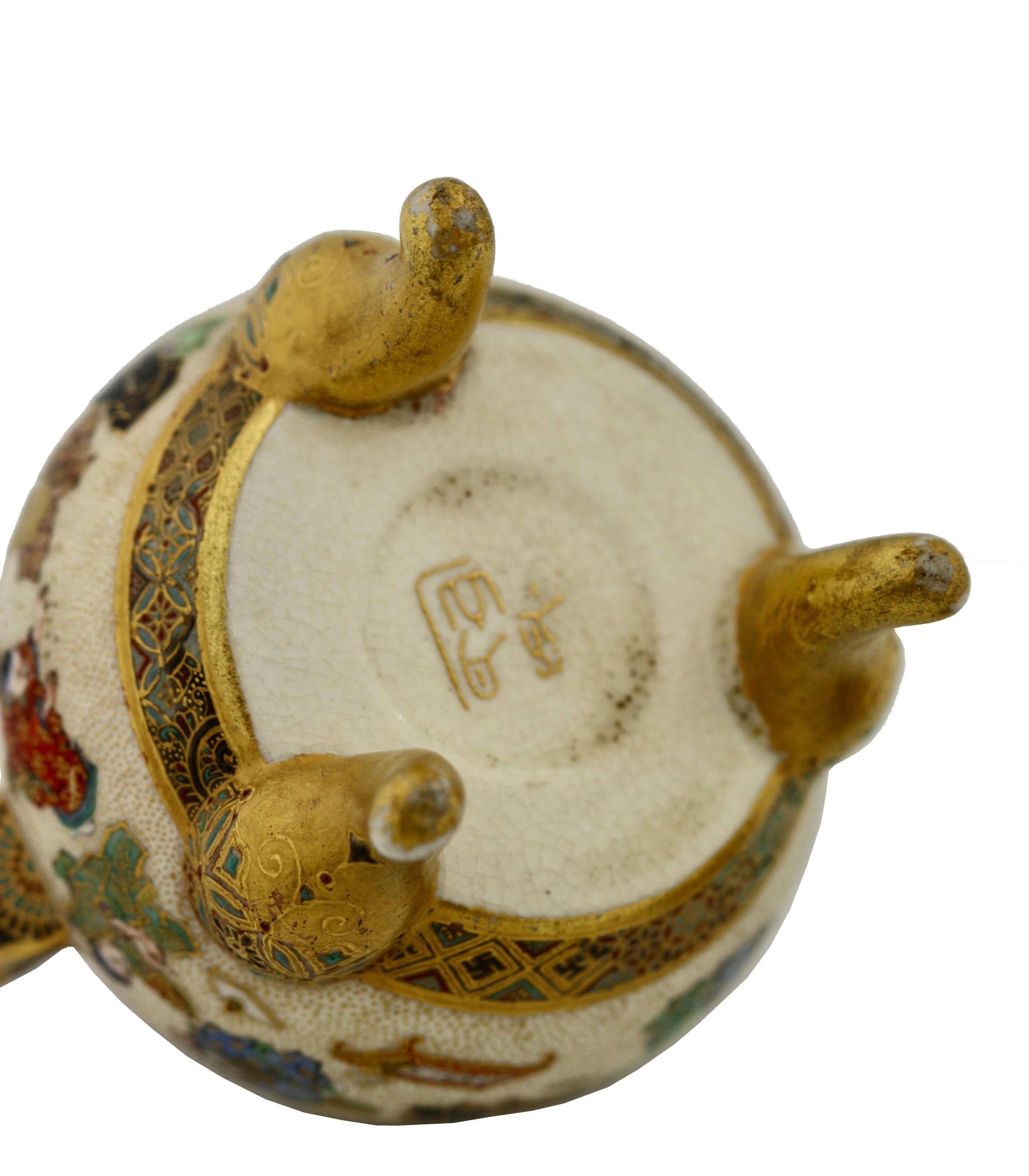 A Satsuma Koro and cover by Yabu Meizan, Osaka, 1853-1934, delicately painted with various scenes of children playing, the top with lion finial, raised on three scrolling feet, with gilt seal Yabu Meizan, height 3 1/2 inches.