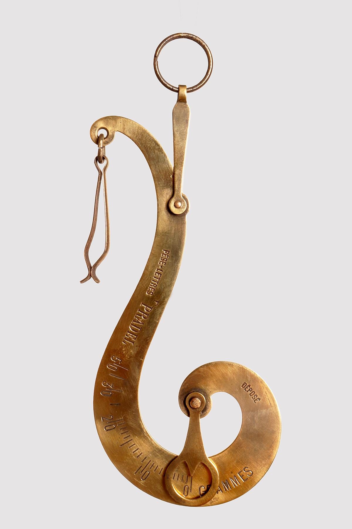 A scale weighs travel letters of gilt brass, S-shaped round plate of gilt brass. Ring to hold it between the fingers of one hand and pliers to insert the travel letters to be weighed. Pradel, France circa 1880.