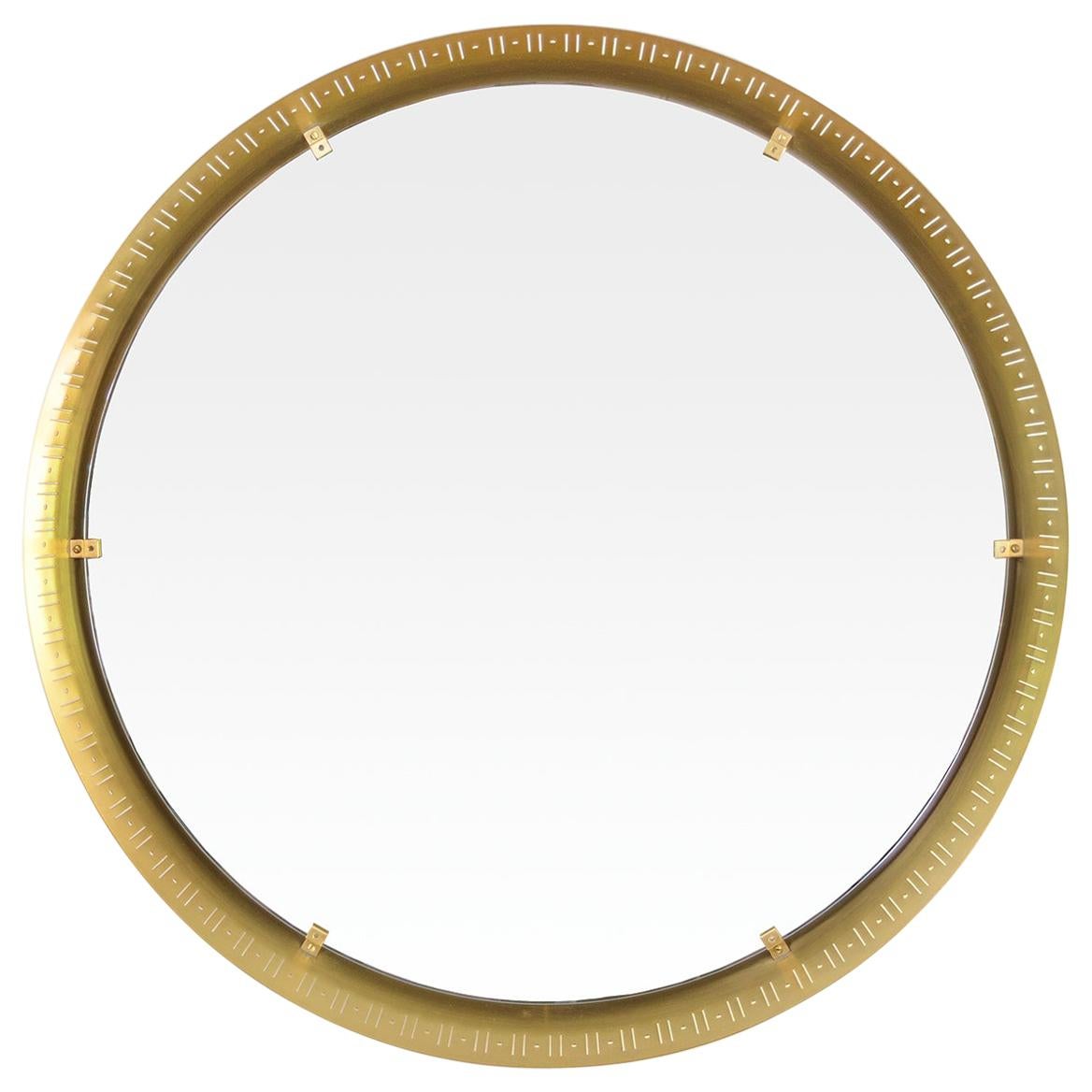 A Scandinavian Modern, round polished brass mirror. The frame has a “line and dot” design pierced around the frame. The mirror glass appears to float above a reveal. Newly polished and lacquered.
Measures: Diameter 25”, depth 2.5”.
