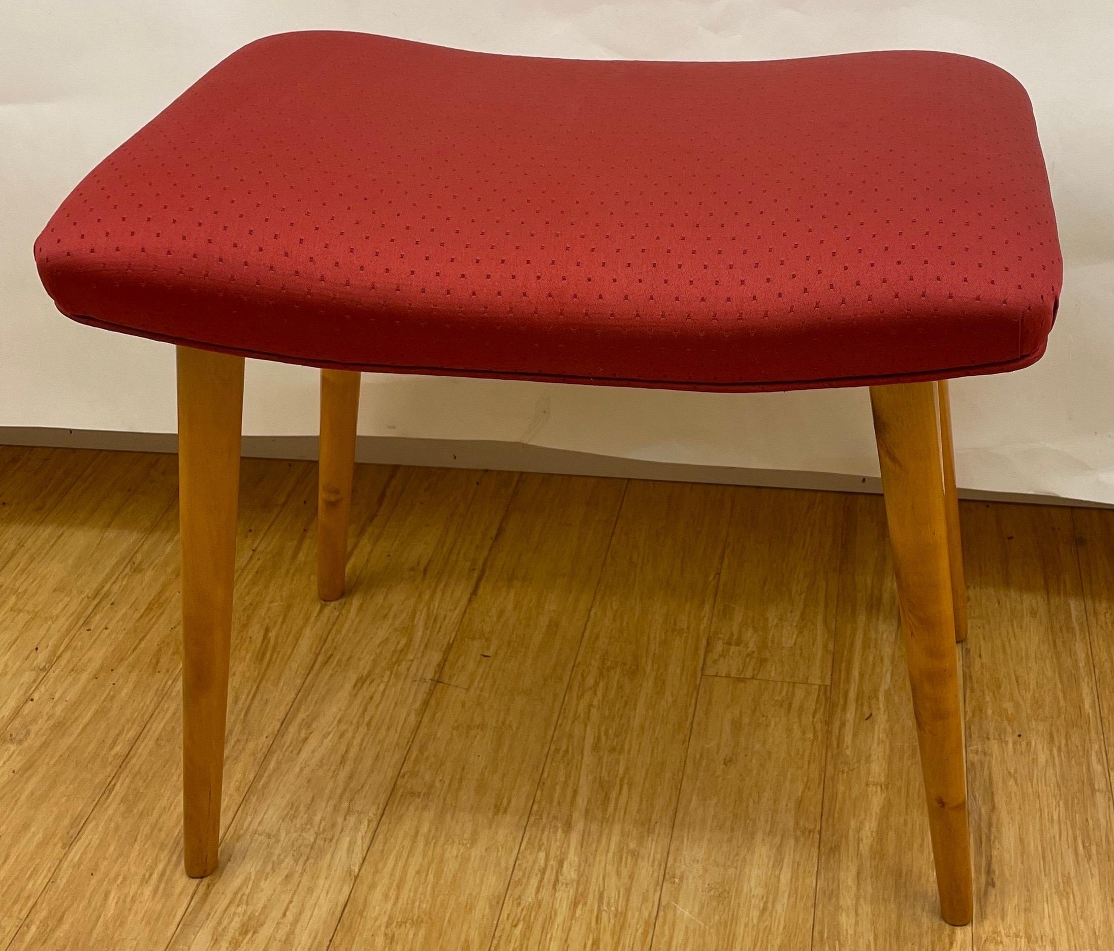 Simple and comfortable, this sleek, single bench features a padded seat atop slender, spooled, golden birch legs.