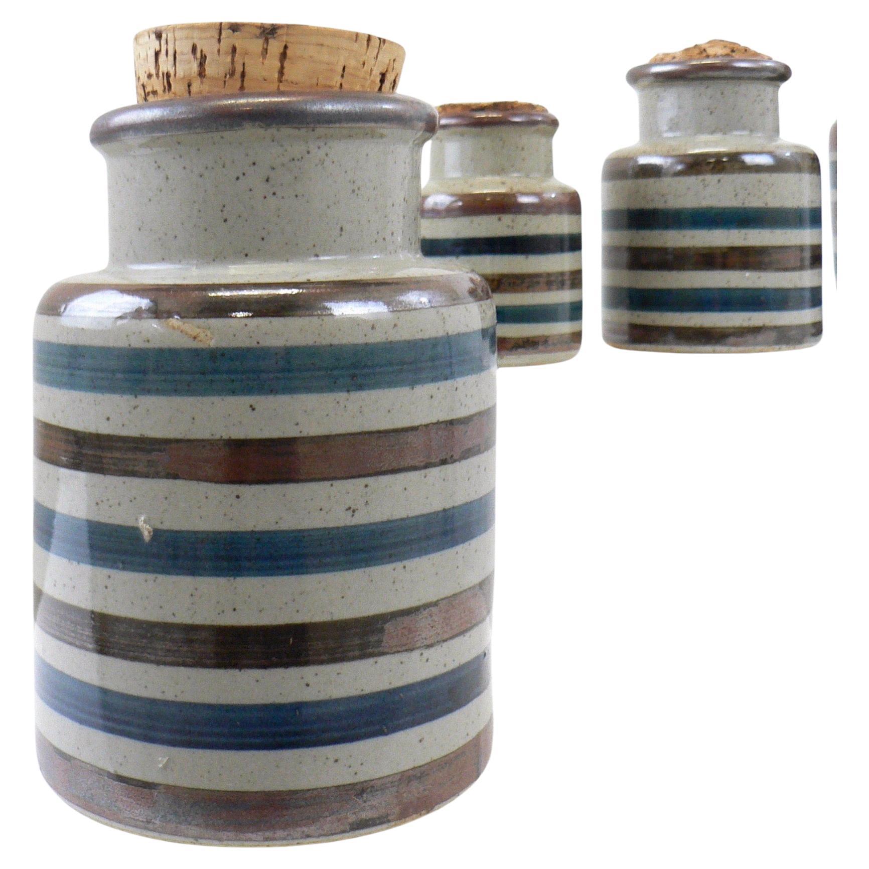 A Scandinavian set of four porcelain spice jars with cork stoppers.

Dimensions:
Height: 16,13,11 and 9
Diameter: 12,11,9 and 7