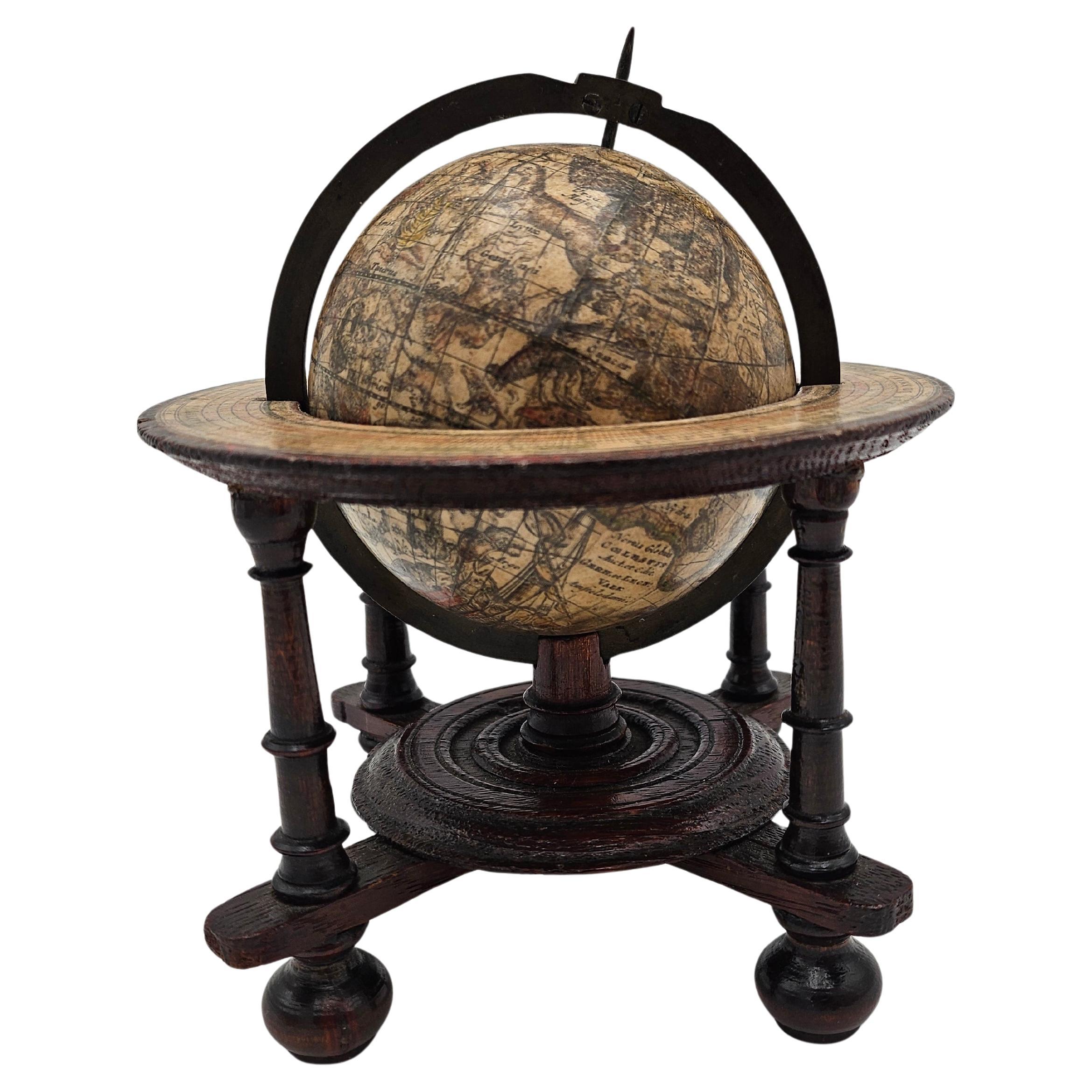 A scarce and beautiful miniature celestial globe produced in Amsterdam. For Sale