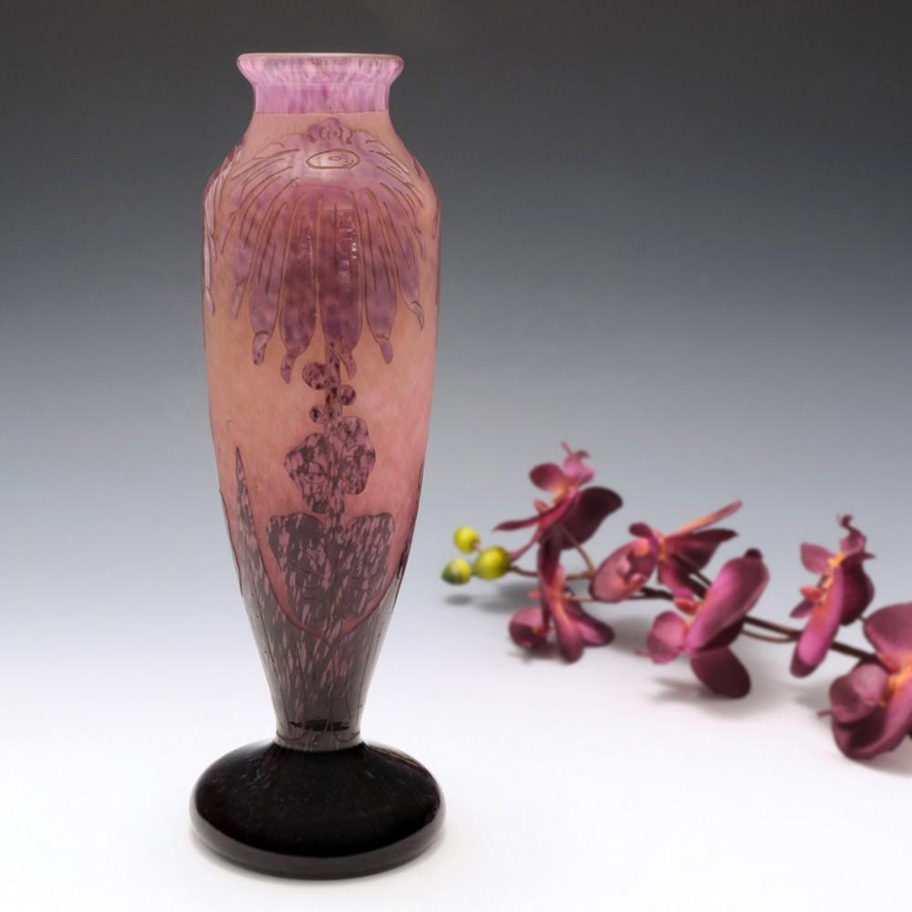 A Schneider vase of classical form with short everted rim and circular pad base from c1925 made in Epinay-sur-Seine, Paris, France. Pale lilac toning to intense purple at the base against an internally pale toning to salmon pink, decorated with