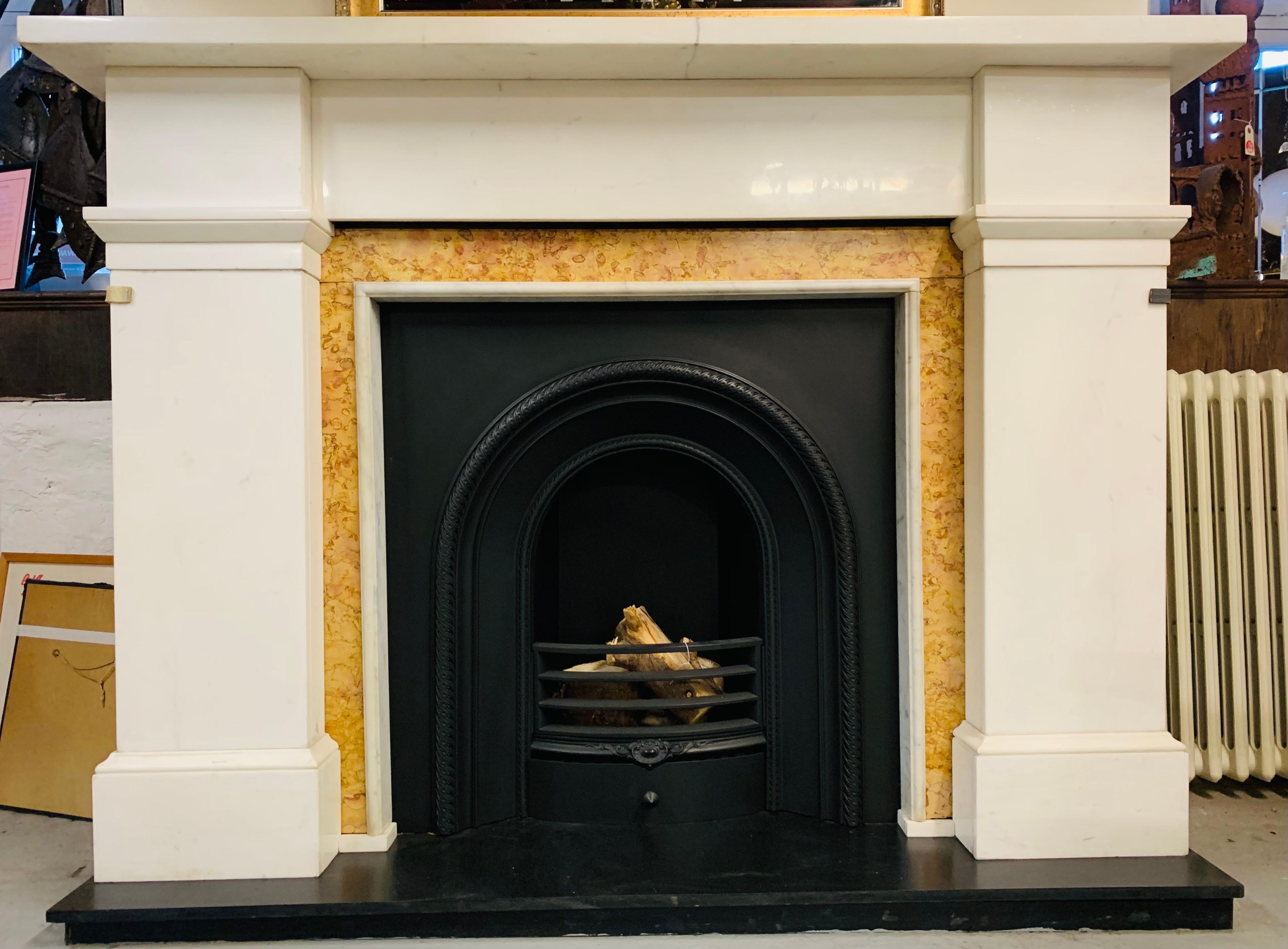A very large and beautiful Scottish statuary marble fireplace surround in a typical Edinburgh design with later Sienna marble ingroungs -complete with a rich heritage. A large and generous shelf sits above an unadorned frieze, flanked by large jambs