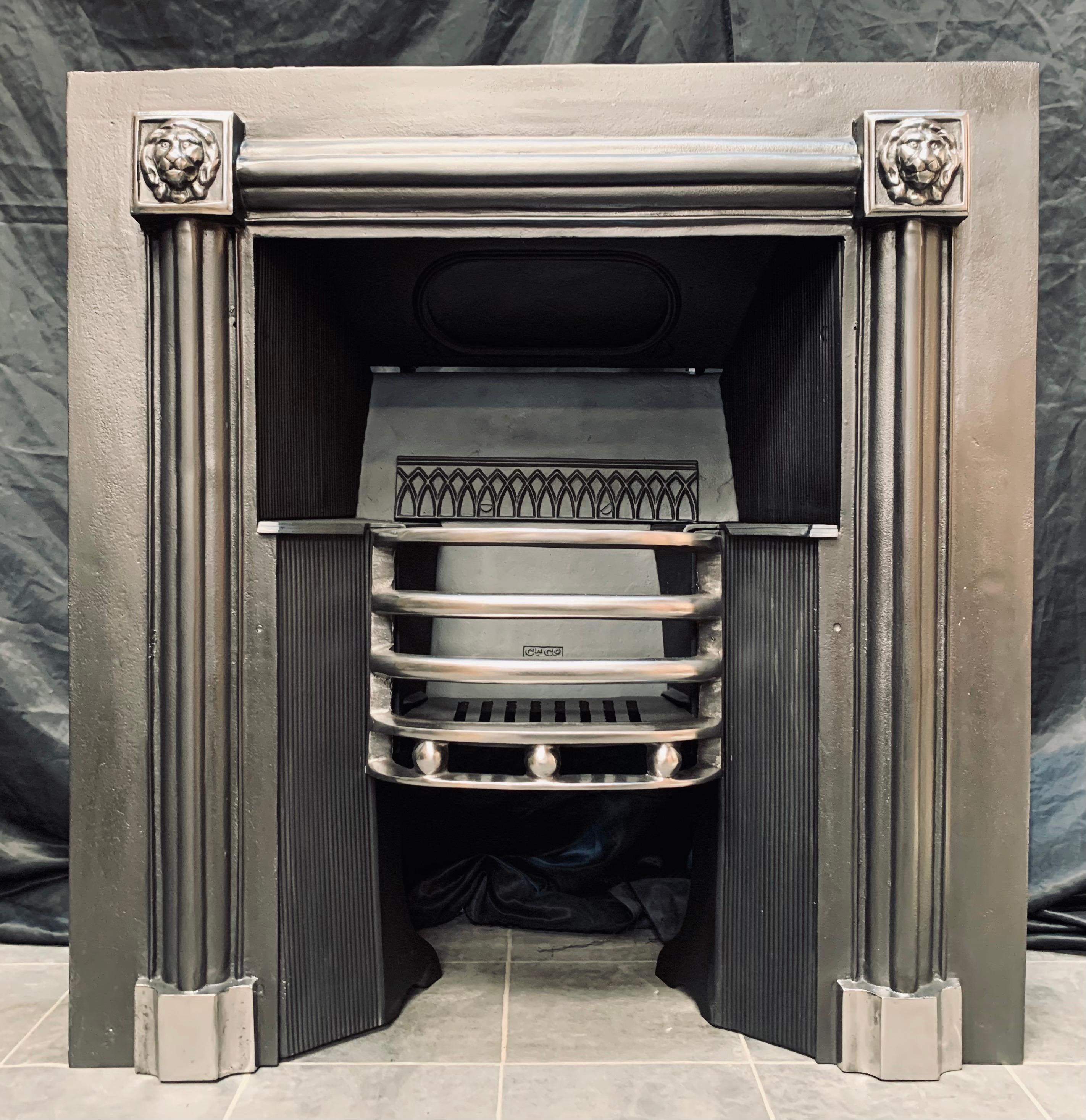 A versatile Scottish Georgian Manner Cast Iron Hob Grate fireplace insert by the renowned foundry Carron of Falkirk. A generous outer plate hosting raised barrel moulding with high relief Lion masks to each corner, finishing on shaped foot blocks. A