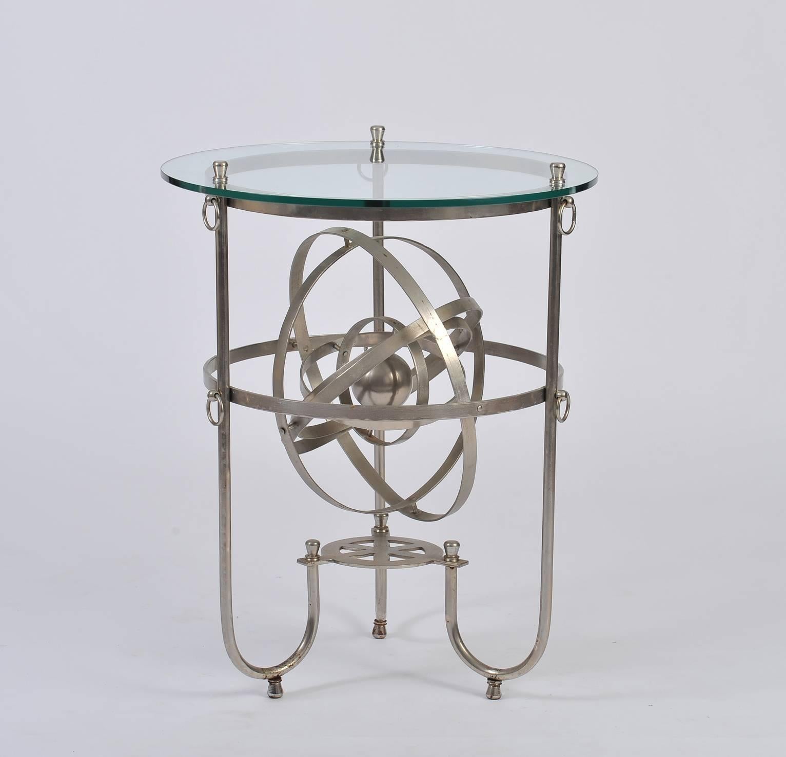 A brushed steel and circular glass top gueridon or side table, incorporating a fully rotating armillary sphere
France, circa 1950.
 