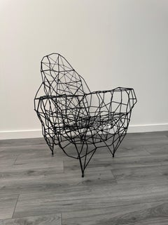 A sculptural iron & string armchair by Gerard Coquelin