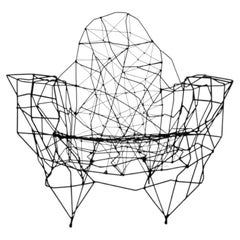 A sculptural iron & string armchair by Gerard Coquelin