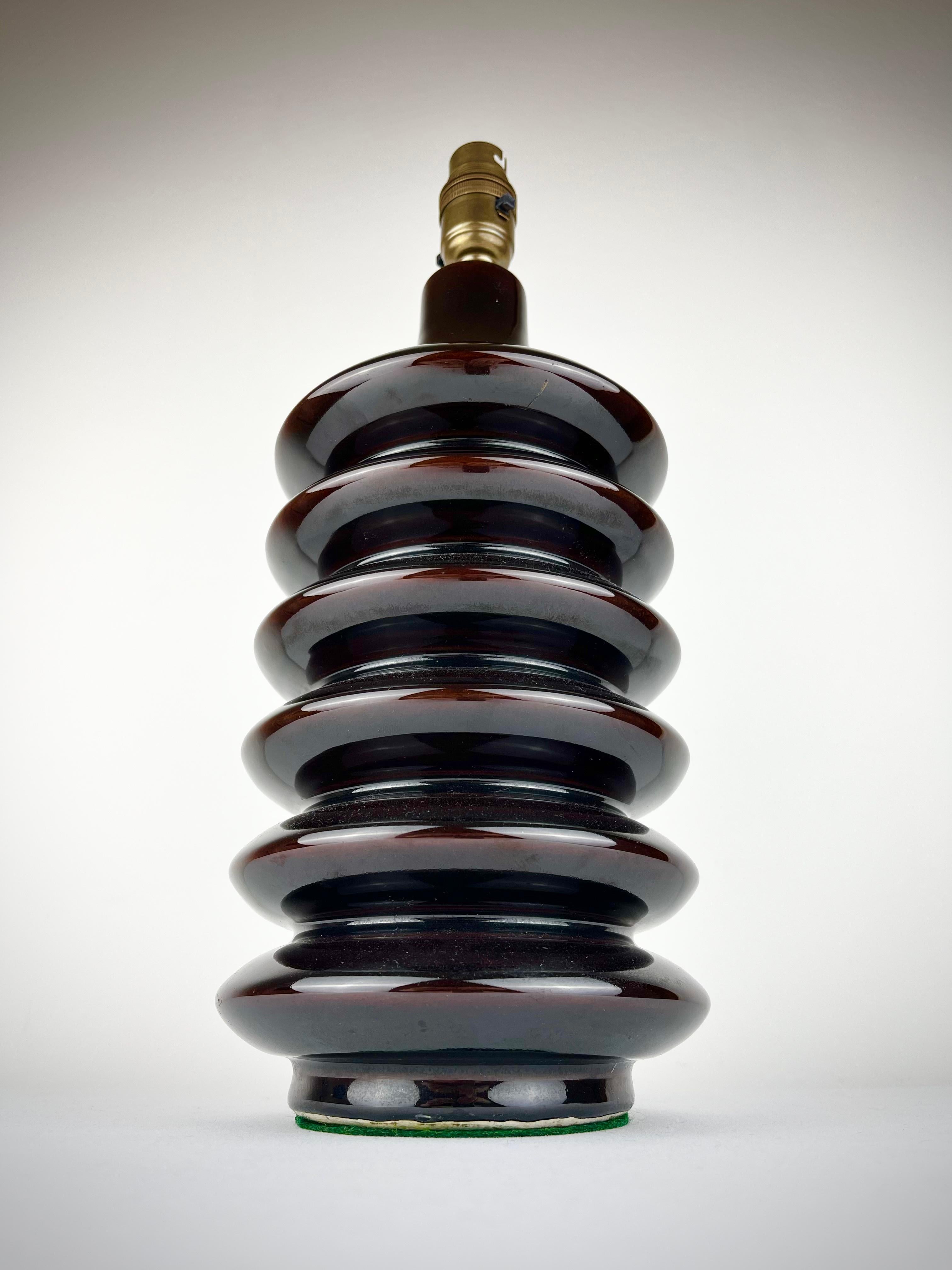 A beautiful mid century ceramic lamp base with a distinctive, sculptural form. Excellent condition.
Dark chocolate in colour, it has been rewired with a vintage style braided cable, recently PAT tested, and is ready to be paired with a shade of your