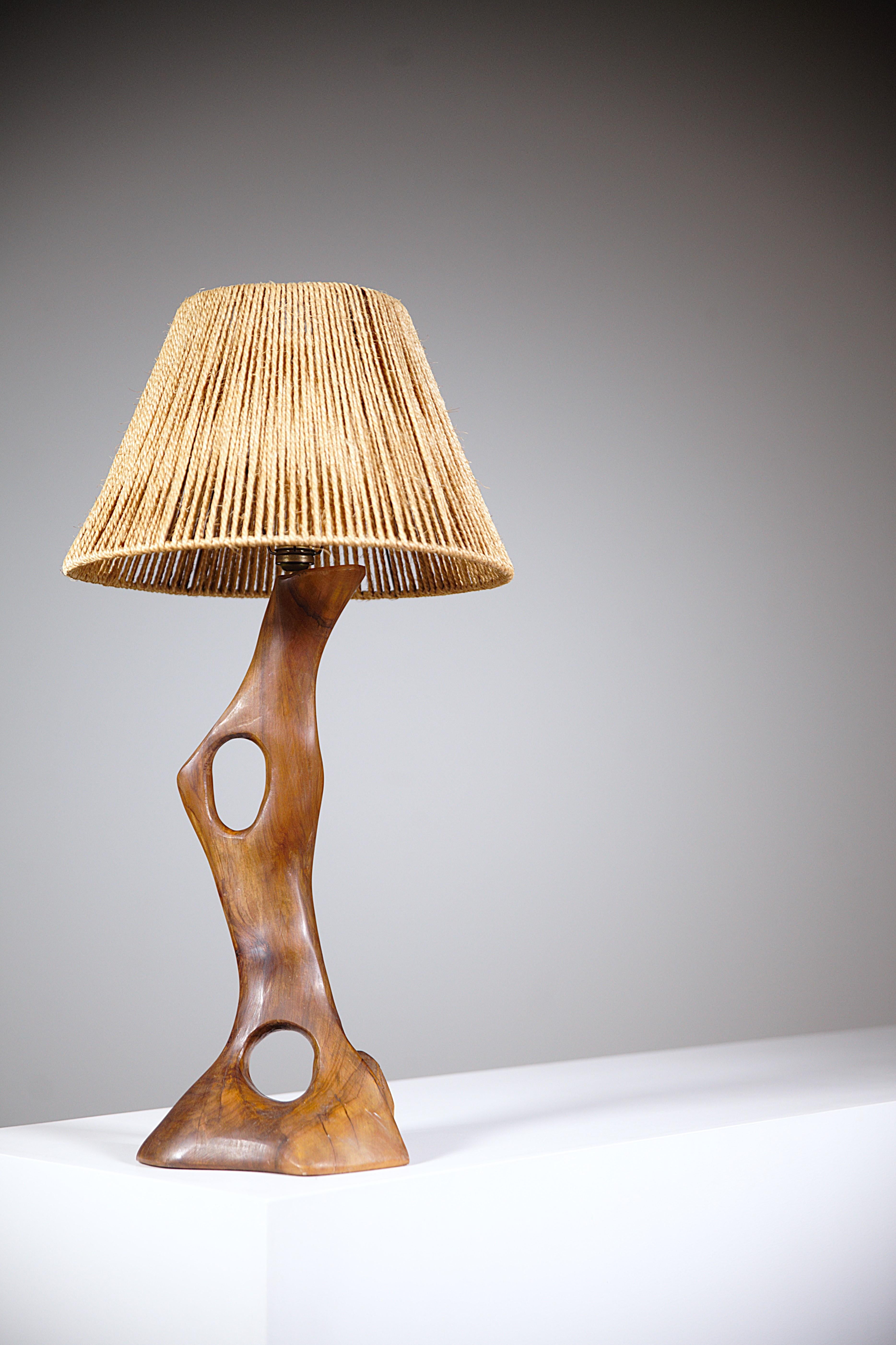 A Sculptural Olive Wood Lamp South of France 1960's

With its original rope lampshade.

Nice Shape and patina.

Measurement :  Lamp base only :  Height : 48cm / Width : 20 cm / Depth : 17cm
                           Lamp with lampshade : Height :