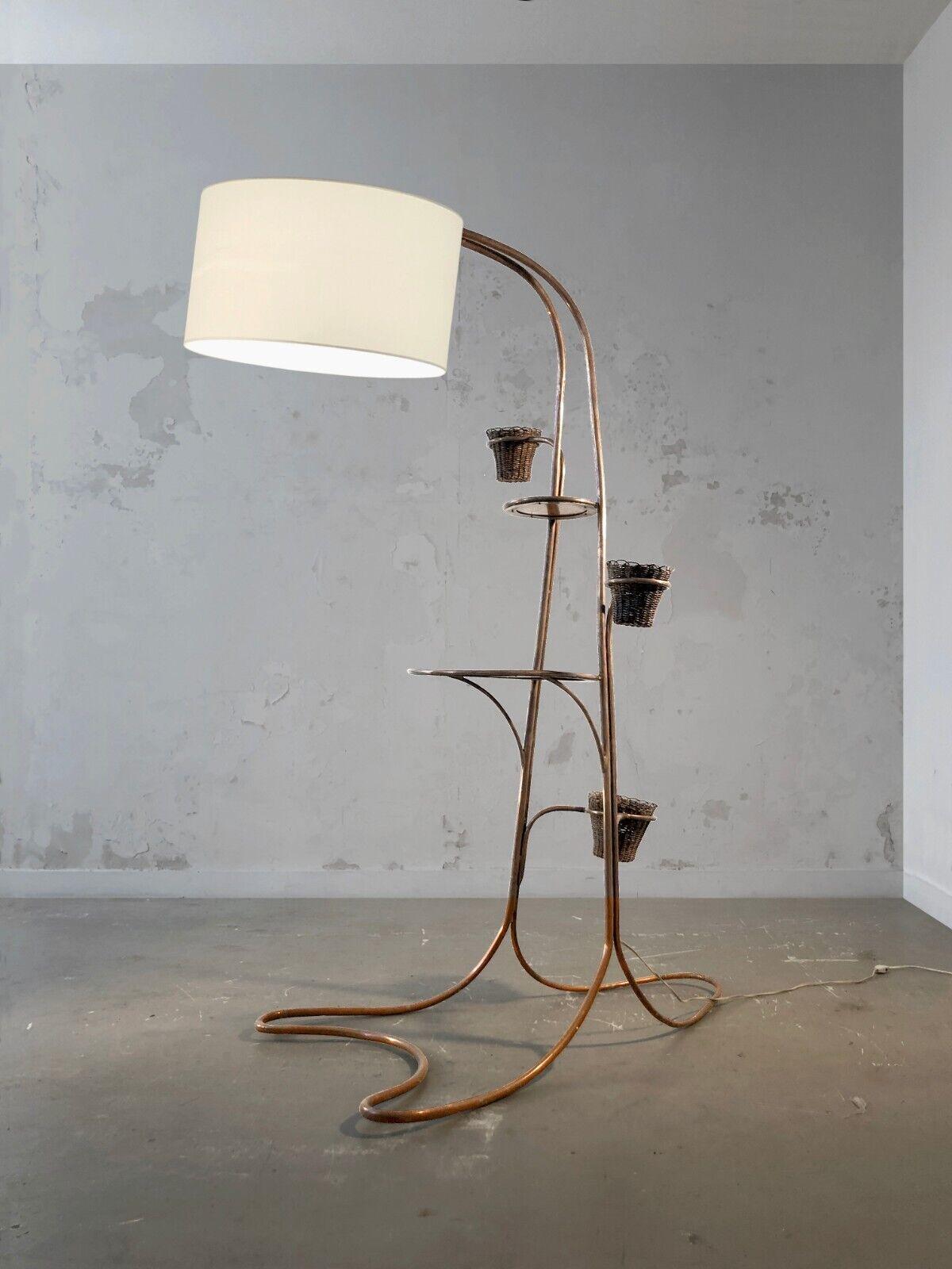 A huge, spectacular and sculptural plant holder floor lamp, Free-Form, Modernist, large Free-Form structure in copper-plated tubular brass, welded and folded, 2 circular wooden shelves, 3 plant holder arms with pots in woven rattan, the whole topped