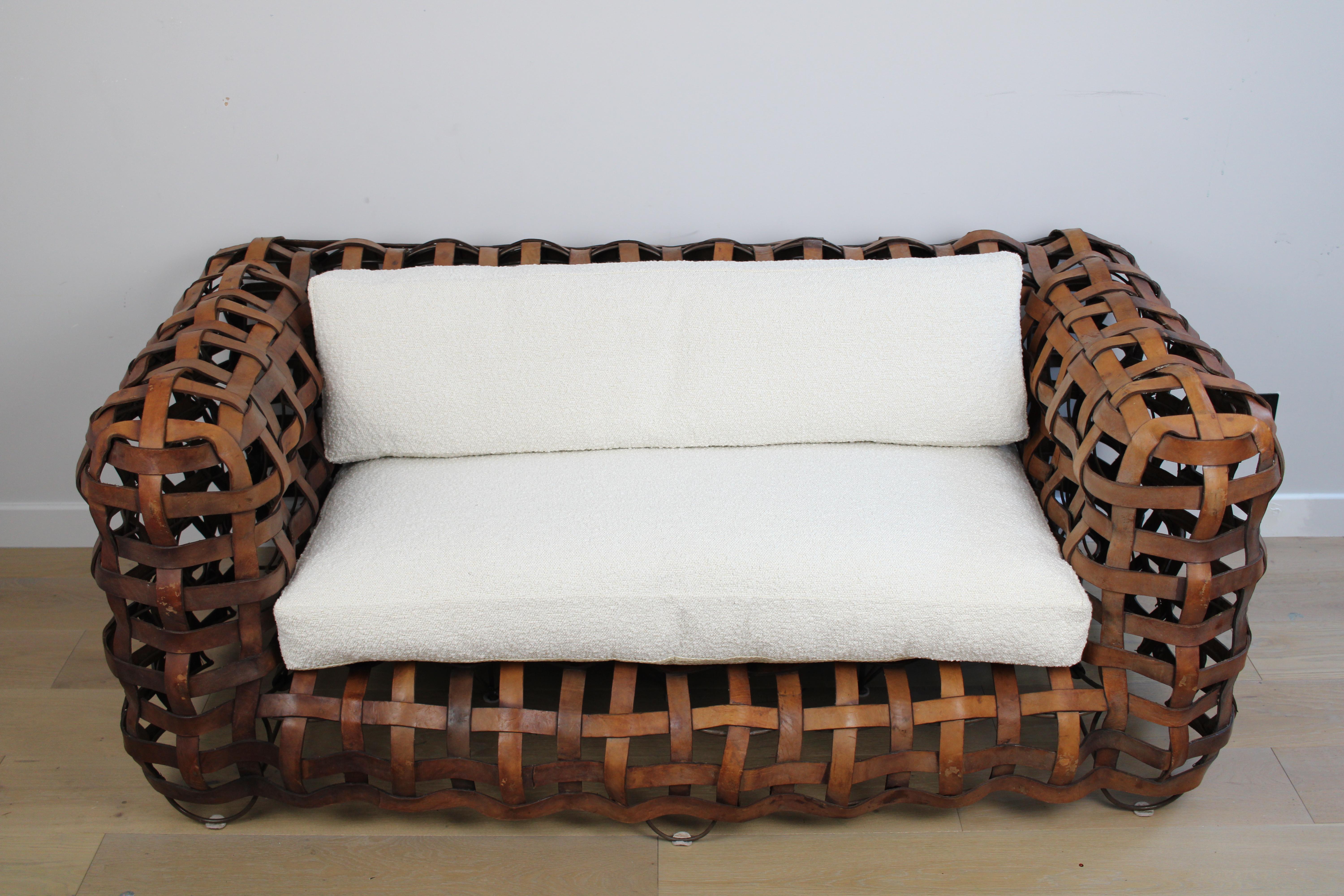 A sculptural Vintage woven leather strap sofa with feather cushions in boucle For Sale 6