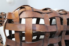 A sculptural Vintage woven leather strap sofa with feather cushions in boucle