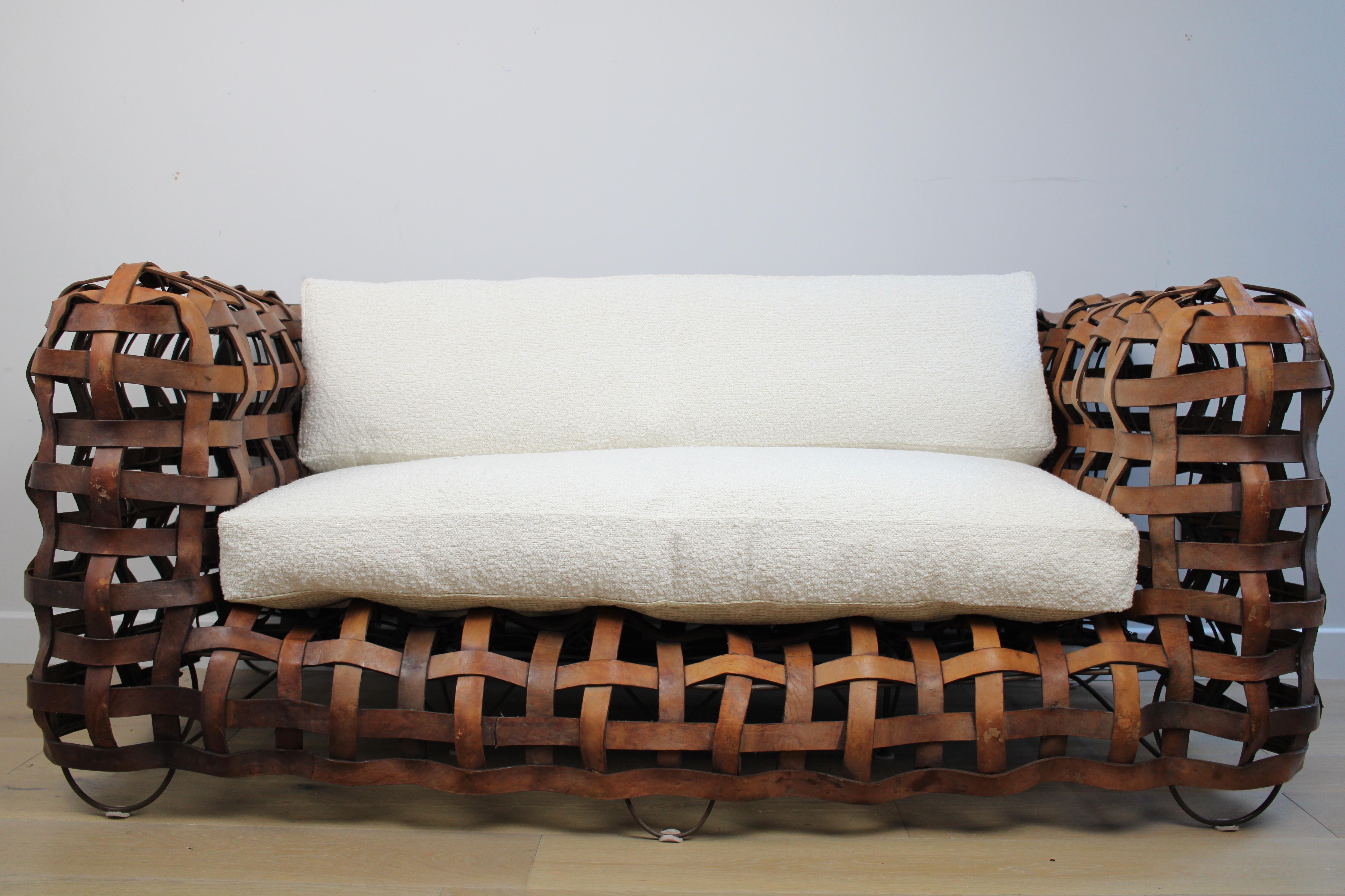 20th Century A sculptural Vintage woven leather strap sofa with feather cushions in boucle For Sale
