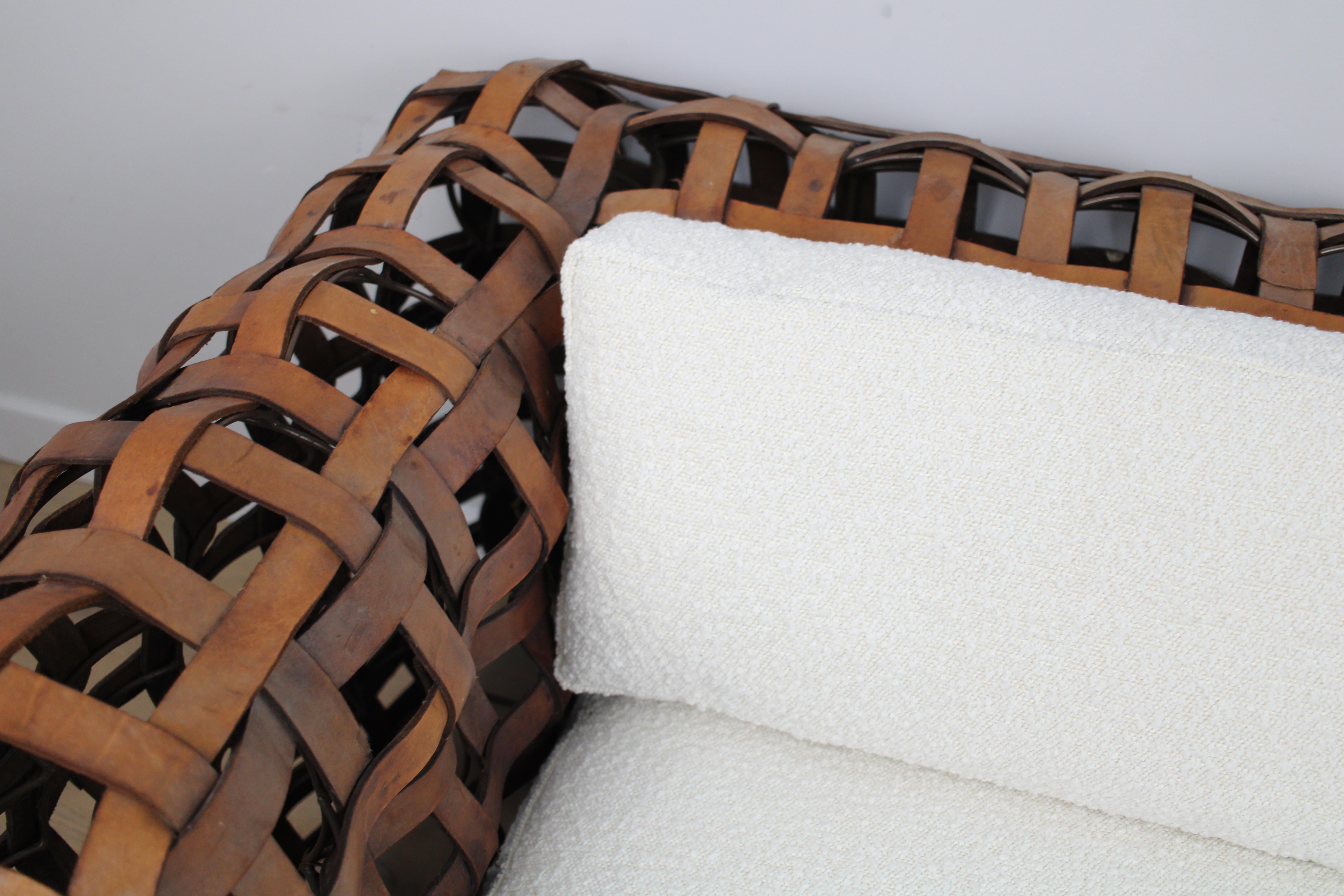 A sculptural Vintage woven leather strap sofa with feather cushions in boucle For Sale 1