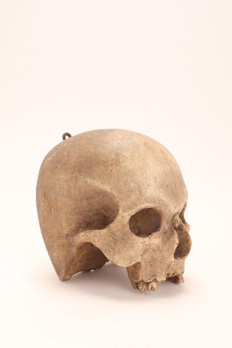 A wooden sculpture of a skull, depicting a Vanitas. Made to hang on a votive chapel. Italy, early 17th century.