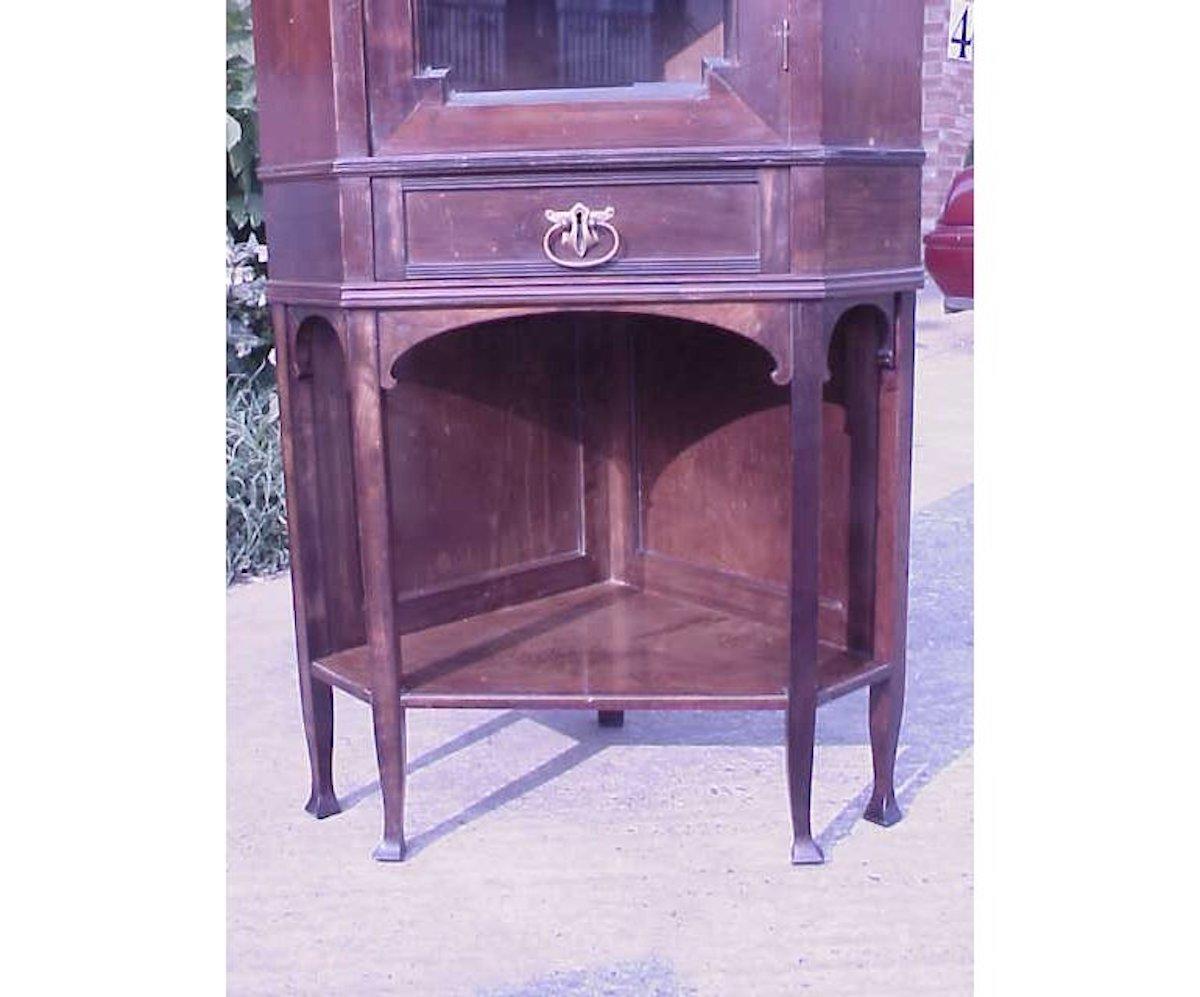 Early 20th Century Secessionist Style Walnut Corner Display Cabinet with Stylized brass Handles For Sale