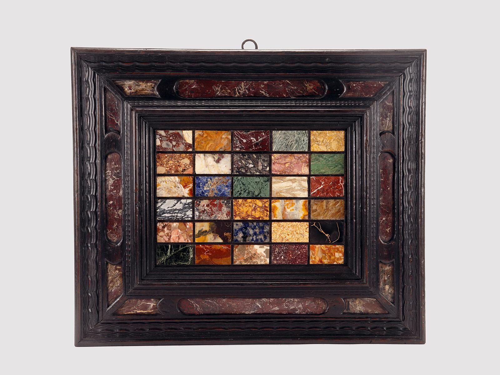 A selection of antique Grand Tour marbles, profiled in black (ebony wood), inserted in an ebonized walnut wood frame, with red Levanto marble inlays. the back of the frame with parts in larch wood. The sample panel is inserted in marquetry of 30