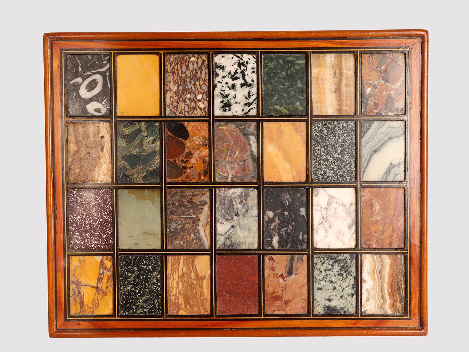 A selection of antique Grand Tour marbles. In an inclined display structure made of lacquered cherry wood and profiled in black (ebony wood), a collection of twenty-eight sample examples of marbles, breccias, ancient porphyries. The marbles are