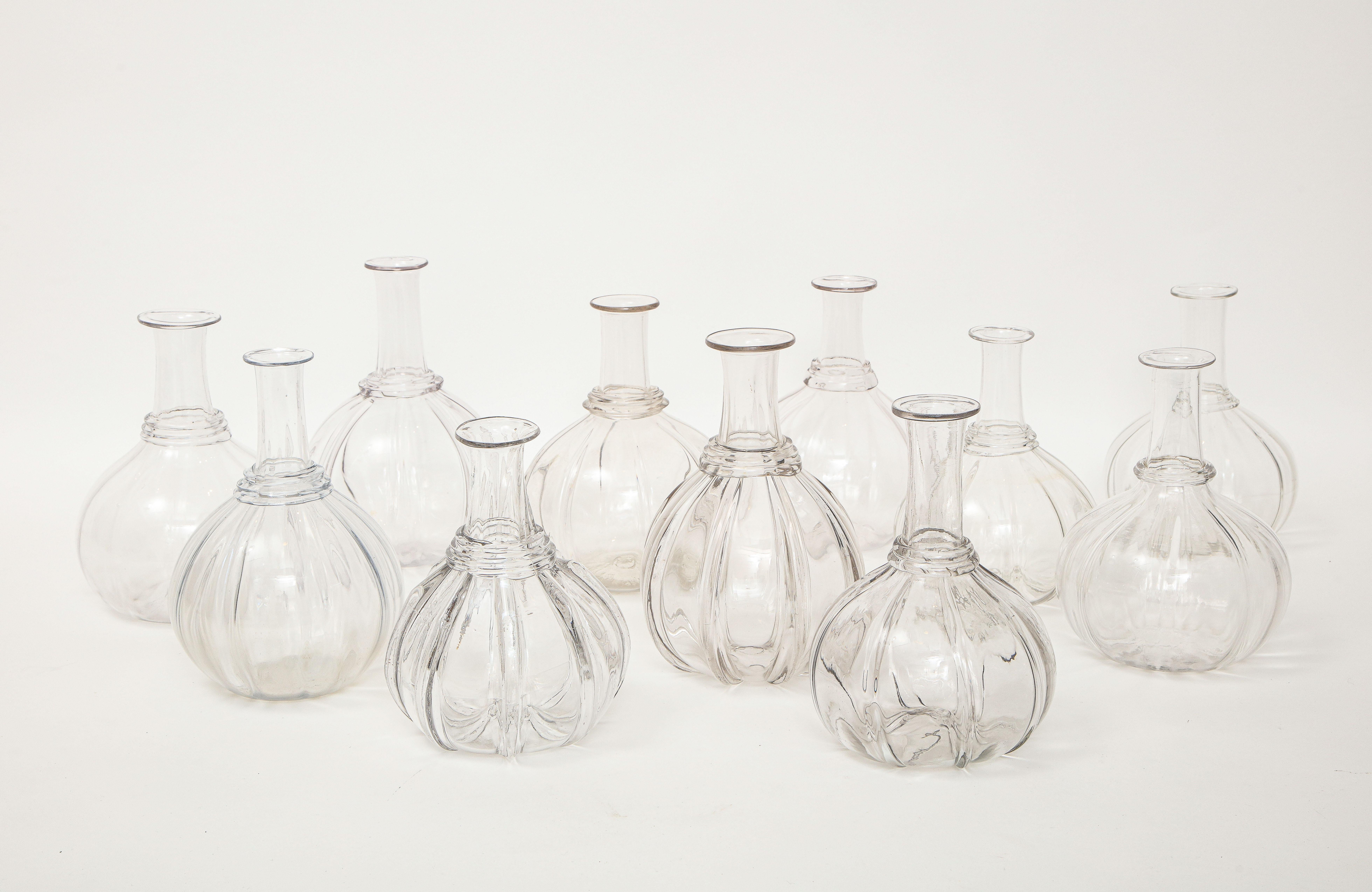 A selection of Swedish blown glass melon form water carafes, 19th Century. All slightly different as they were hand blown by different glass blowers. Originally the smooth top was used to rest a simple drinking glass over. 
They look really nice