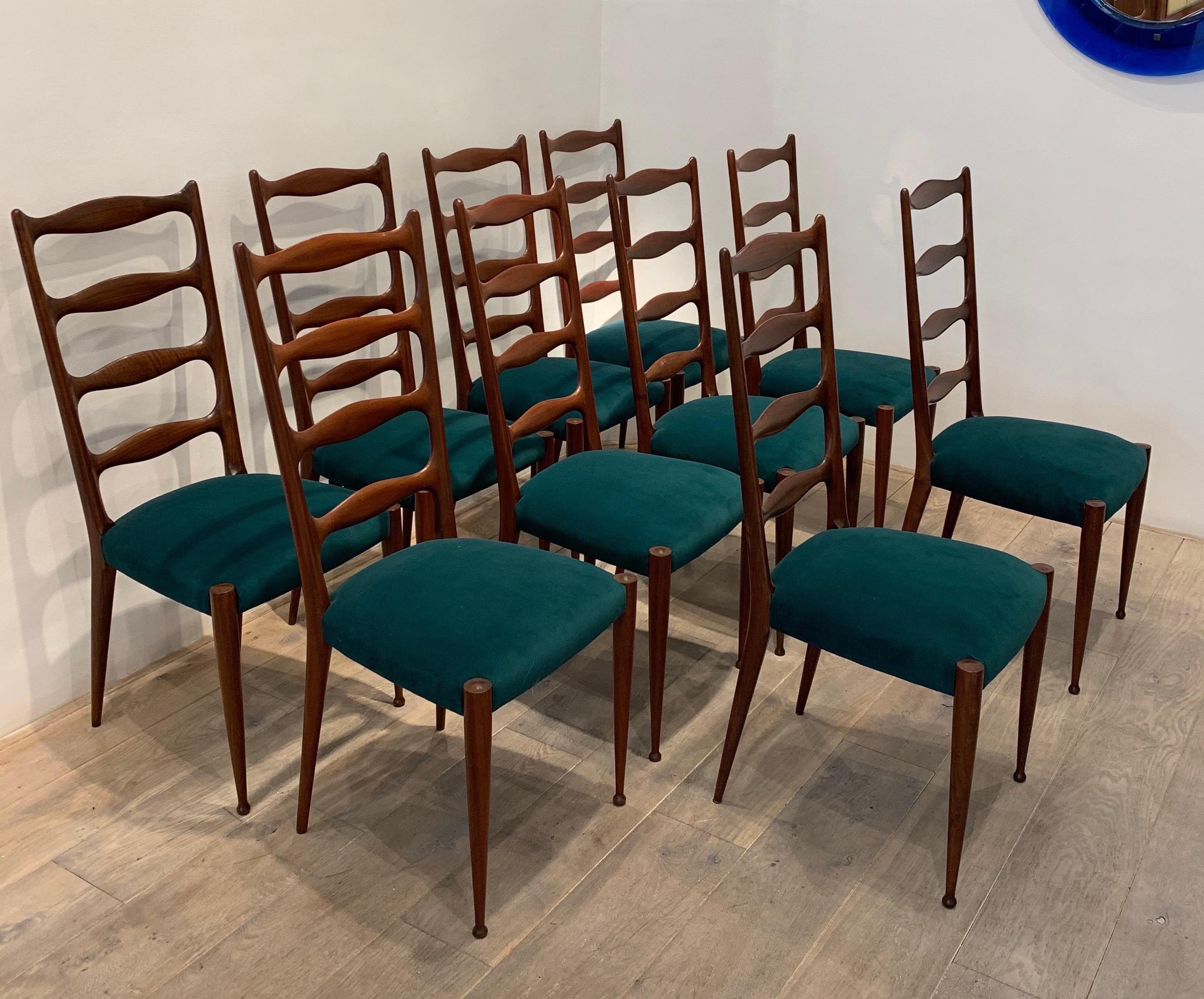 The present model is attributed to Paolo Buffa. They are made of Italian walnut. Based on similar models by Paolo Buffa, the present chairs are attributed to him. Typical is the high back with openings that is found Buffa's work.