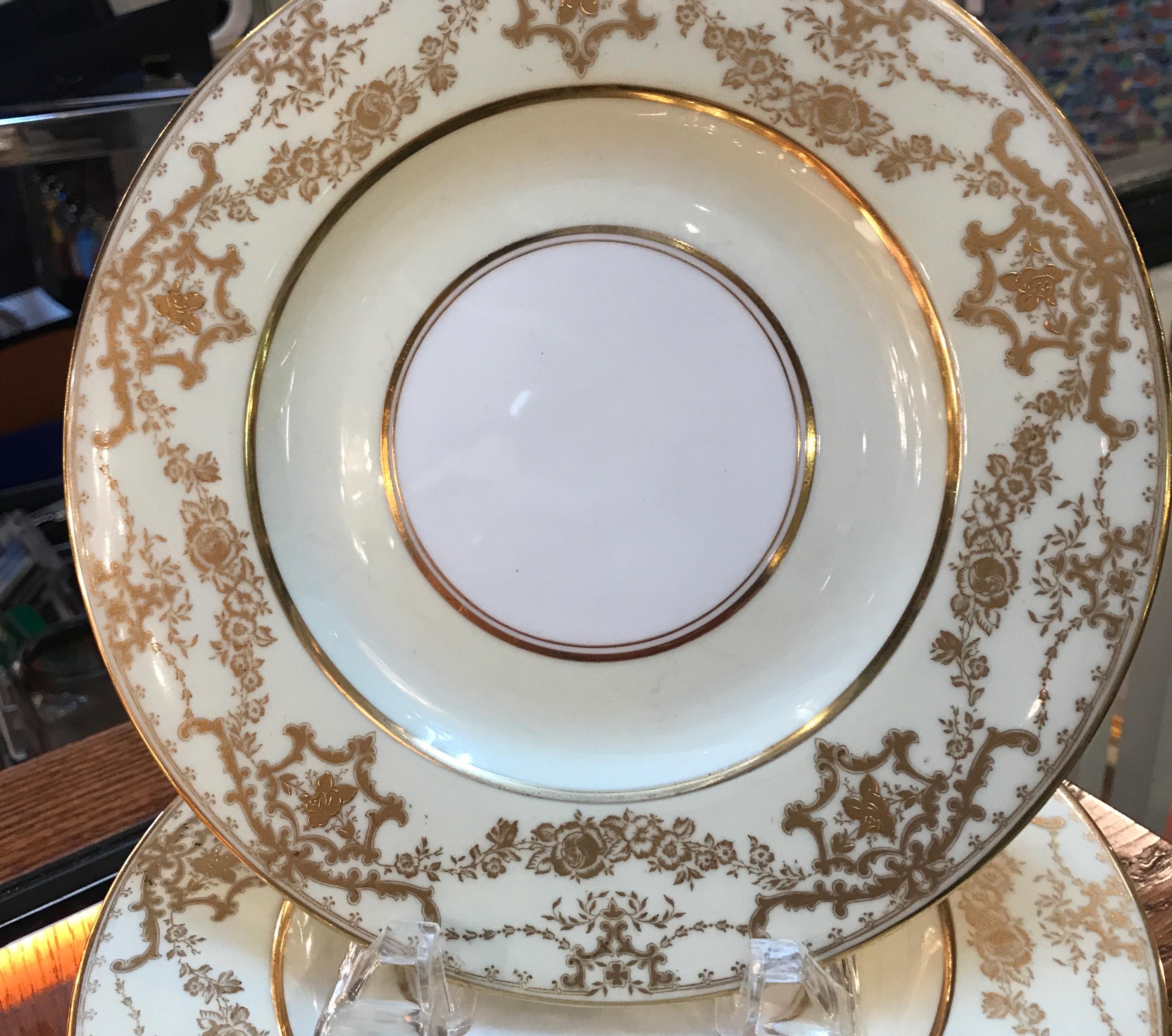 Elegant set of 10 gilt bordered luncheon dessert plates by George Jones, England. Elegant borders with a vanilla background with gilt bands and floral swags. Retailed by Davis Collamore NYC. 9