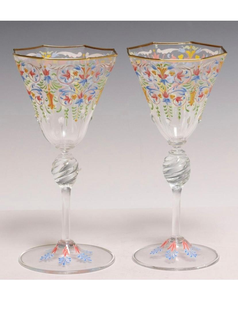 A lovely set of goblets by the Venice Isle of Murano glass blowers of Salviati. This set of eleven pieces feature nicely blown octagonal rims trimmed in 24 karat gold and beautiful multicolor foliate decorations. A knob stem makes them a treat to