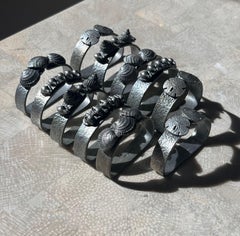 A set of 11 pewter napkin rings with sculpted shells, 1975