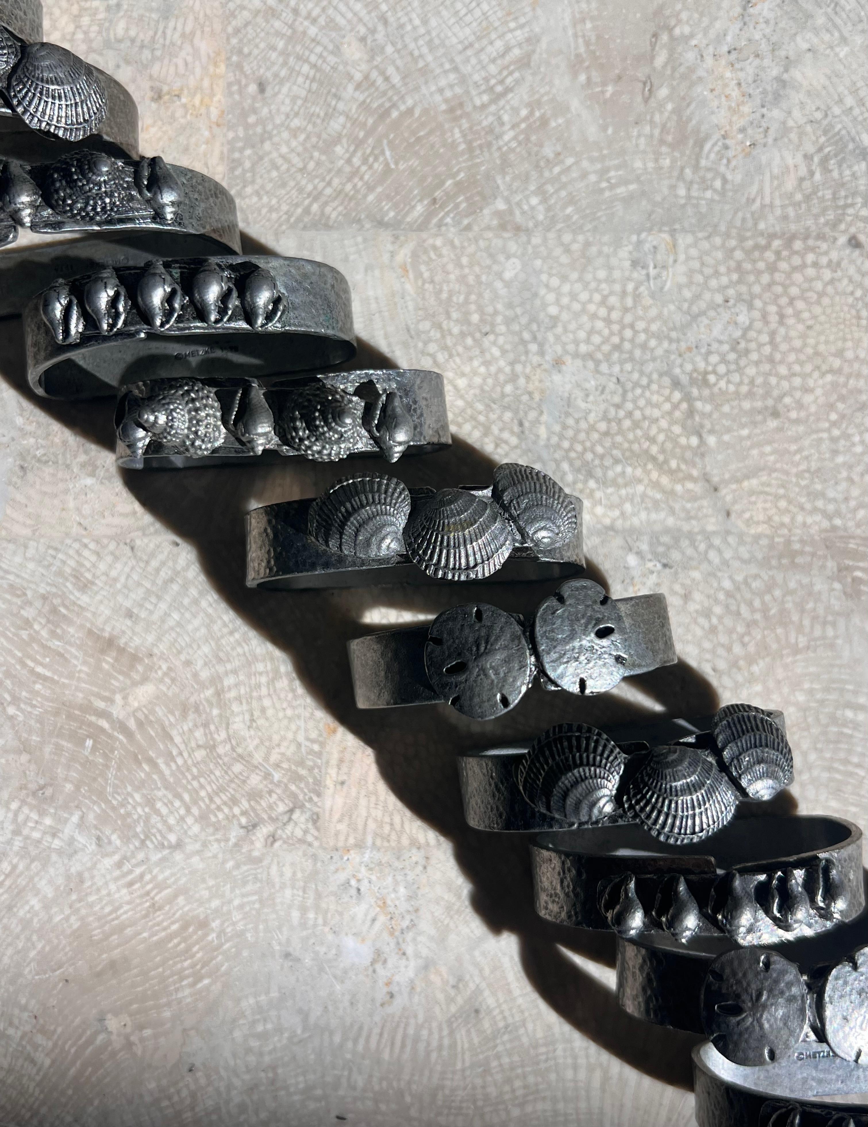 Late 20th Century A set of 11 pewter napkin rings with sculpted shells, 1975 For Sale
