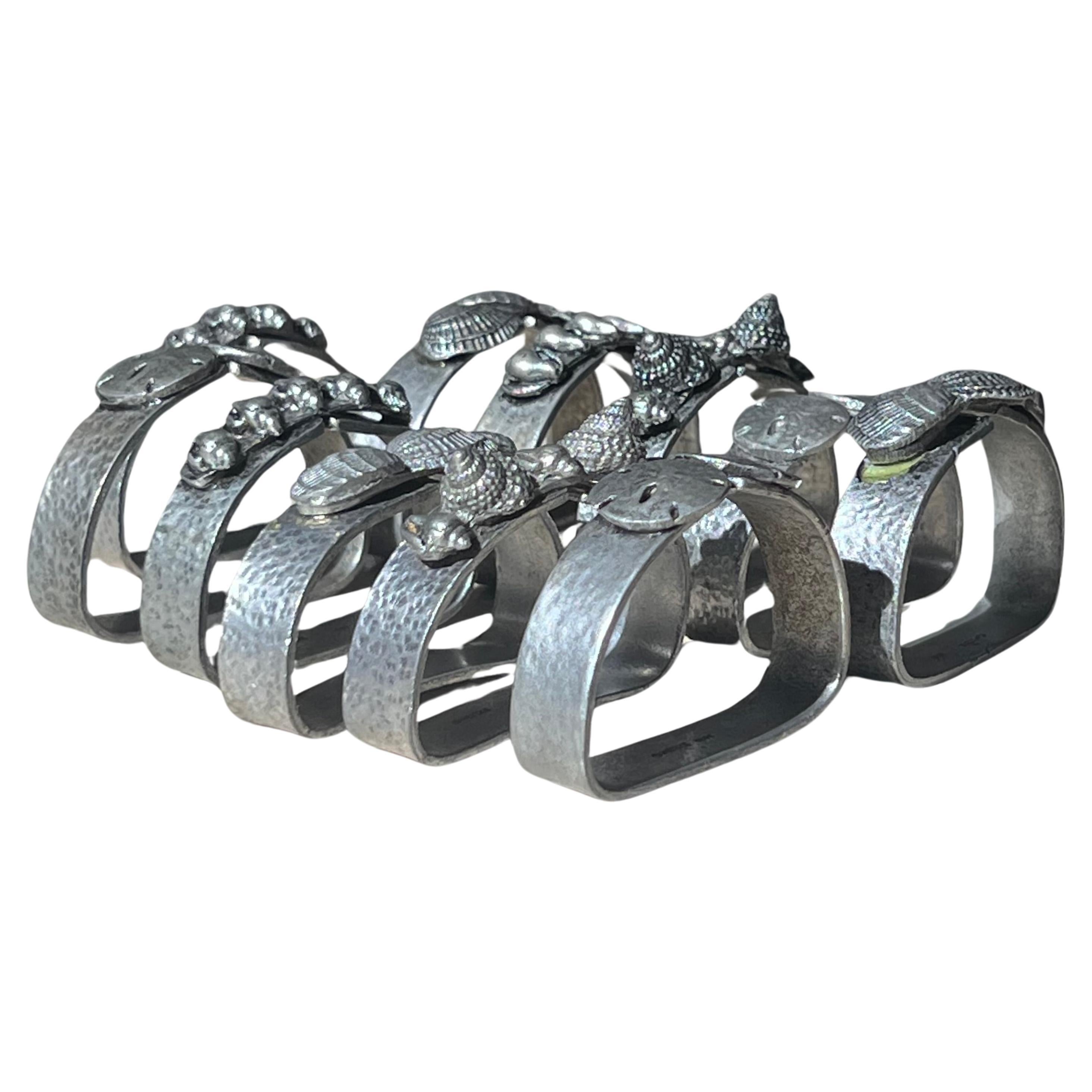 A set of 11 pewter napkin rings with sculpted shells, 1975 For Sale