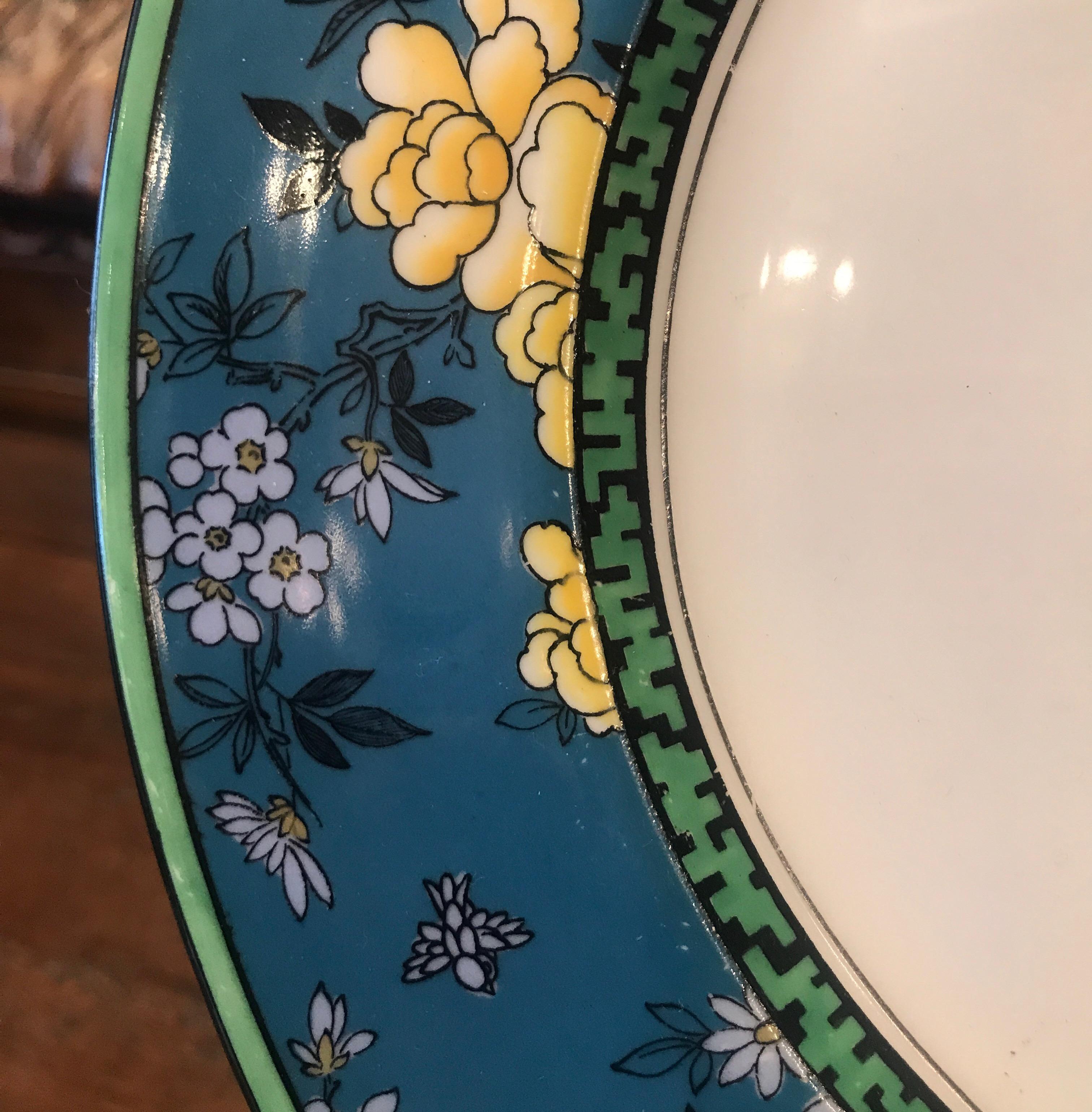Vibrant set of 12 Royal Doulton service plates with rich blue, black, yellow painted Asian Art Deco borders. High style and would look sensational in a cabinet.
These plates were designed by a top Doulton designer, Robert Allen.
Robert Allen, was