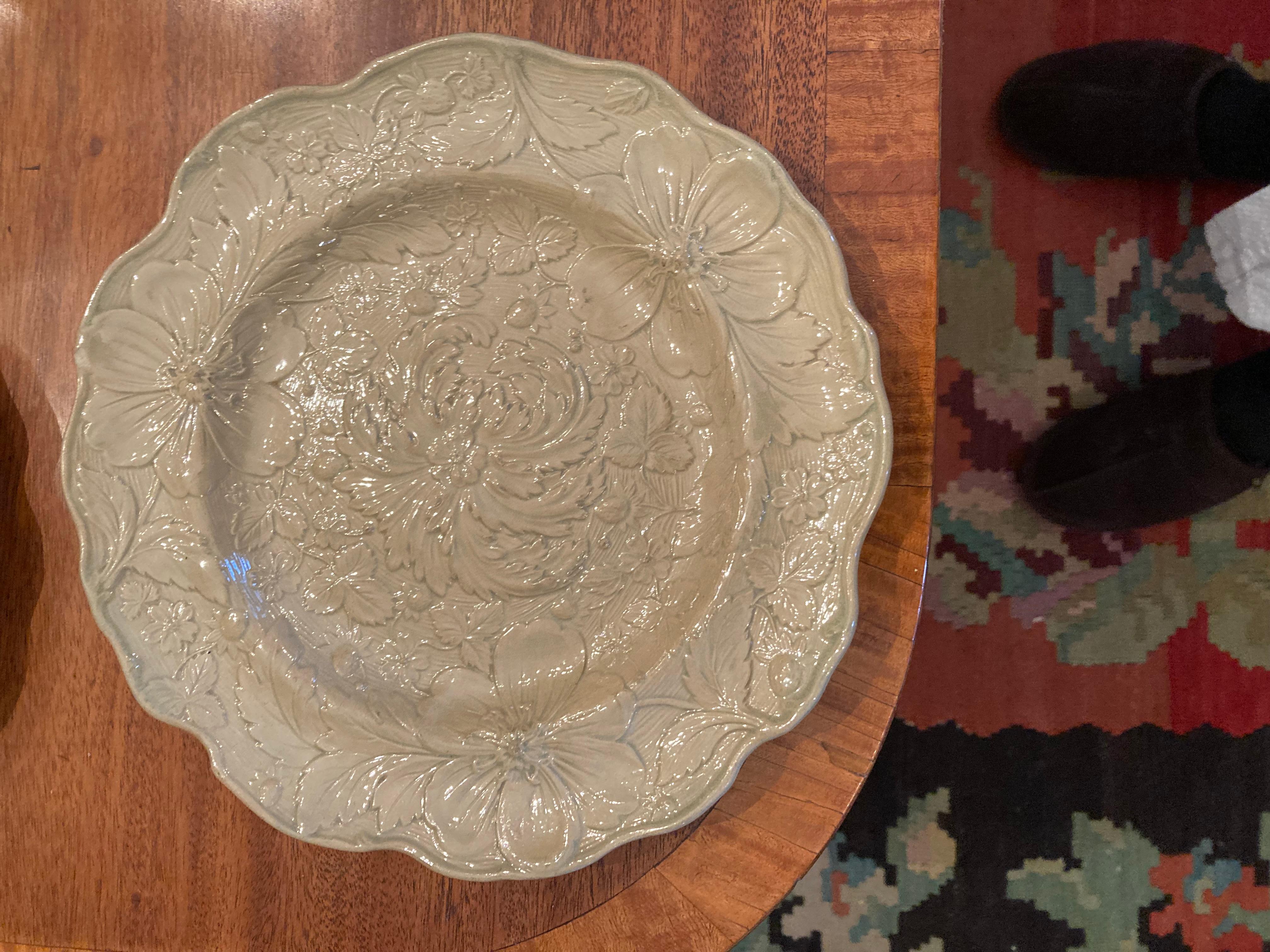 A set of 12 English Drabware Dessert or salad plates with crisp raised decoration of a central chrysanthemum surrounded by strawberry leaves, flowers and buds.