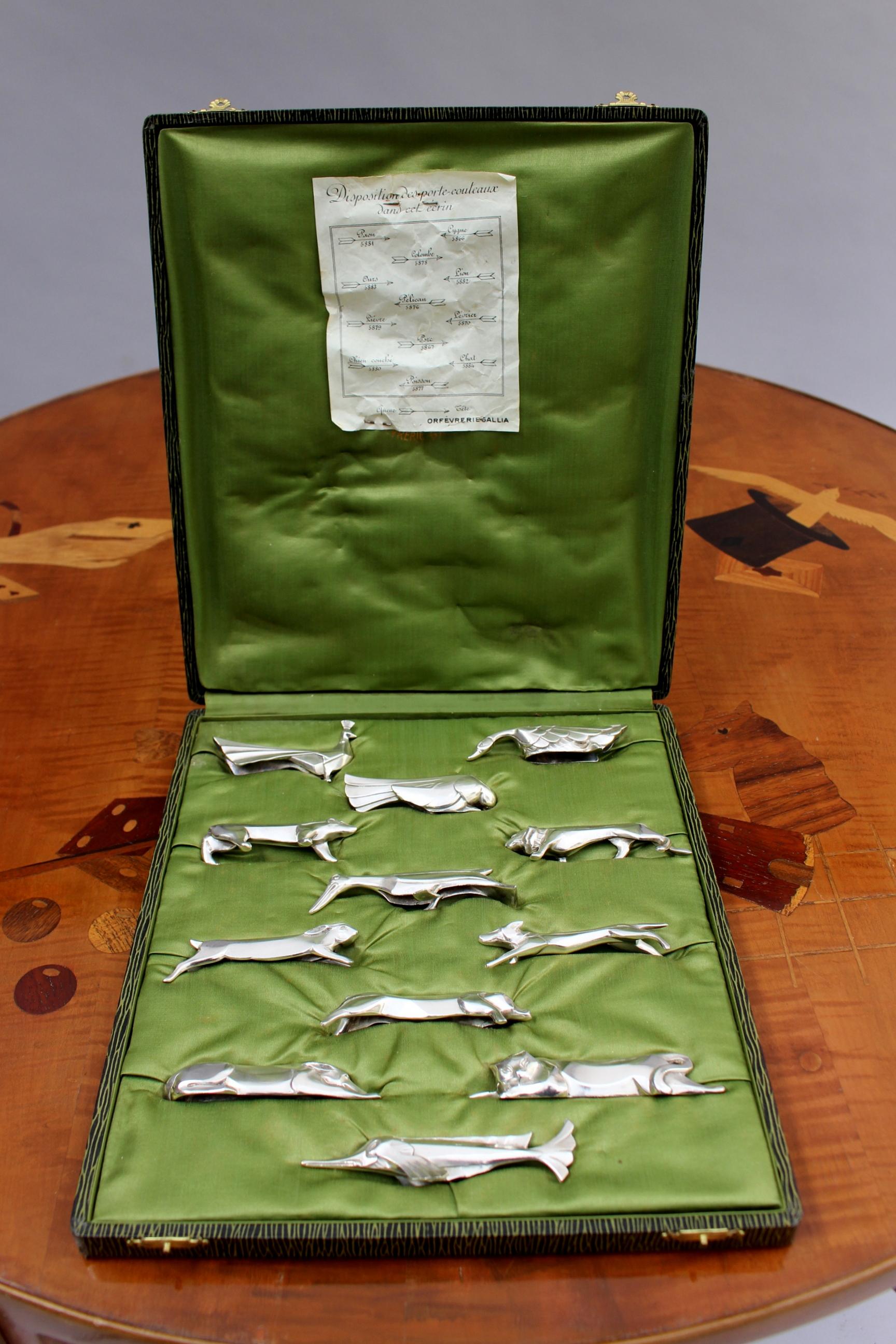 Set of 12 fine French Art Deco silver plated knife rests designed by Sandoz for the Gallia line of Christofle. All 12 animals are different.
Original case.

Average size of knife rests:
H 0.8 inch x L 4.3 inch x W 0.8 inch. 
?H 2 cm. x L 10.5