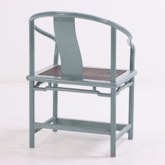 A set of 12 lacquered, rounded-back armchairs with cane seats, C. 1970.