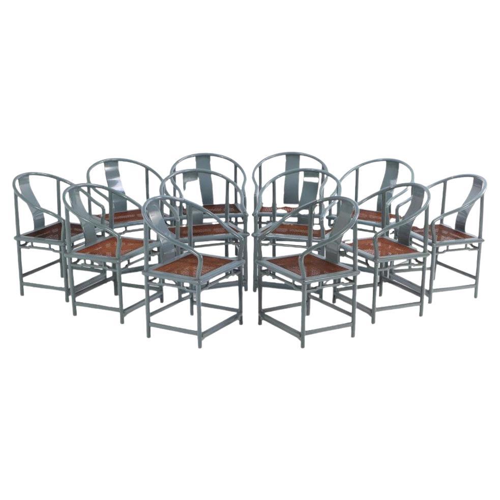 A set of 12 lacquered, rounded-back armchairs with cane seats, C. 1970.